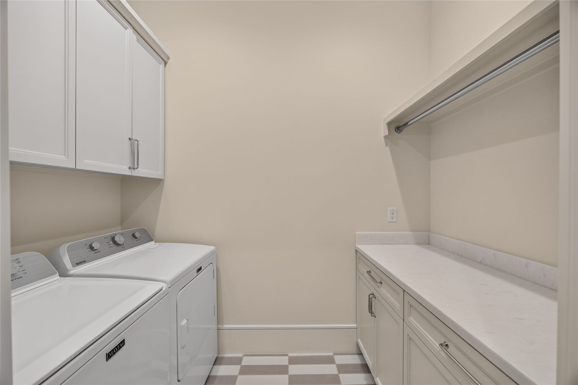 13915 Queensbury Lane, Houston, TX 77079 Conveniently located upstairs laundry room featuring washer and dryer connections, custom upper and lower cabinetry, generous countertop space for folding, and a hanging rod for added functionality. The thoughtfully designed layout makes everyday laundry tasks more convenient.