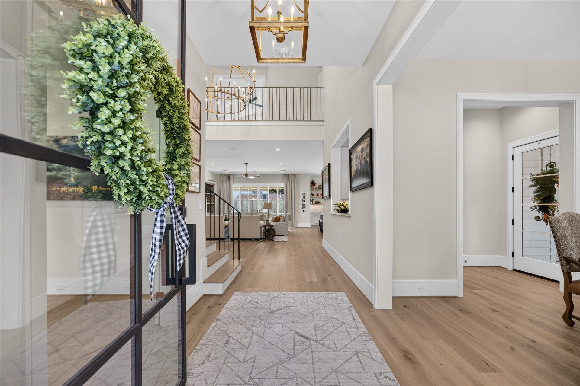 13915 Queensbury Lane, Houston, TX 77079 A welcoming two-story entry makes a beautiful first impression with soaring ceilings, elegant statement lighting, wide-plank wood flooring, and a striking staircase with sleek black iron railings. The open design offers inviting views into the main living areas.
