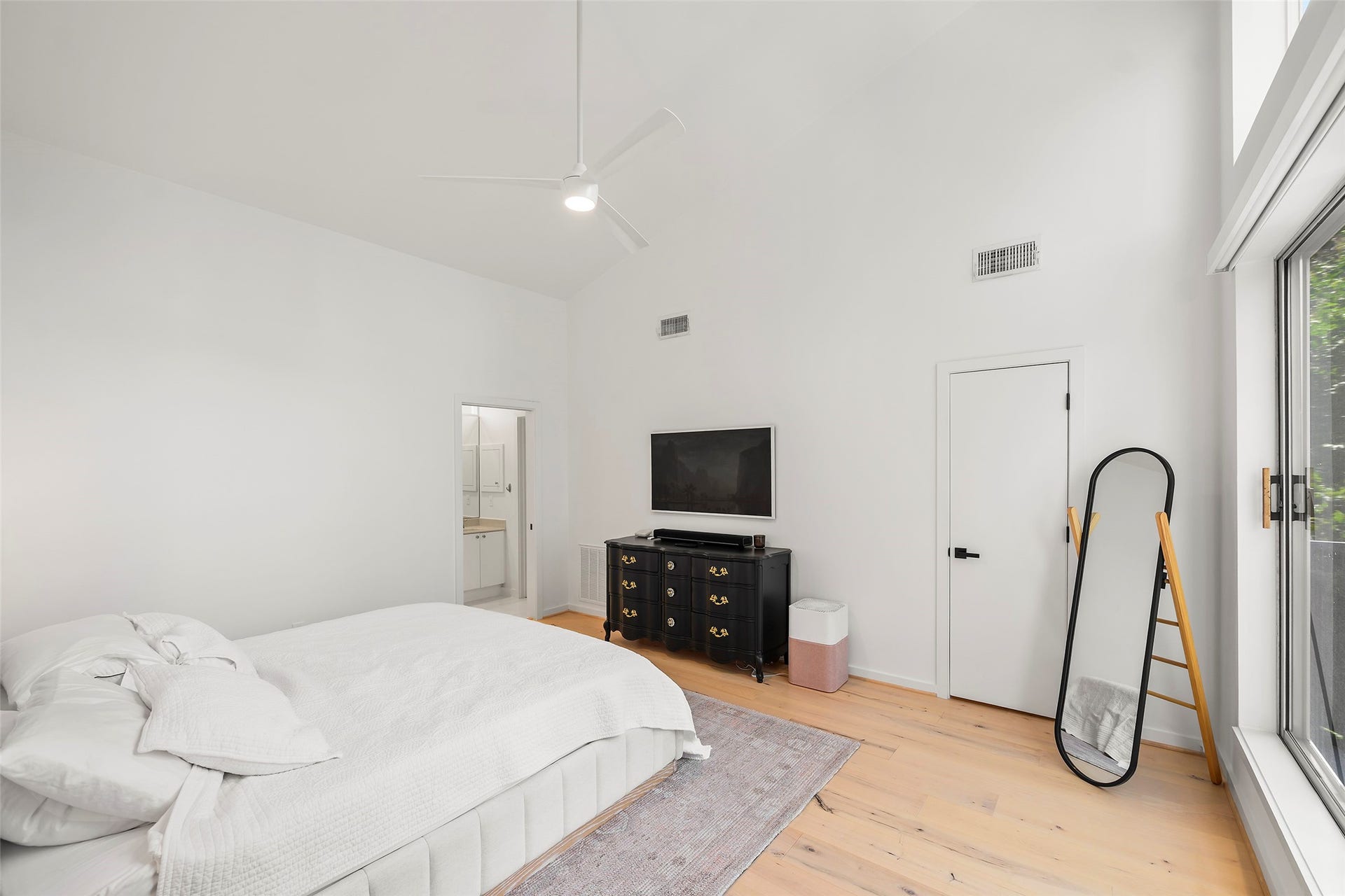 Primary has tall ceilings and electric blinds for shade and privacy