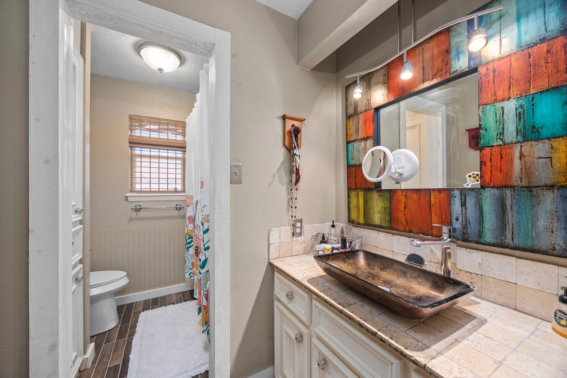 1622 Rambling Stone Drive, Richmond, TX 77406 Shared upstairs bathroom features a distinctive vessel sink, decorative tile accents, and a tub/shower combination with a separate vanity area.