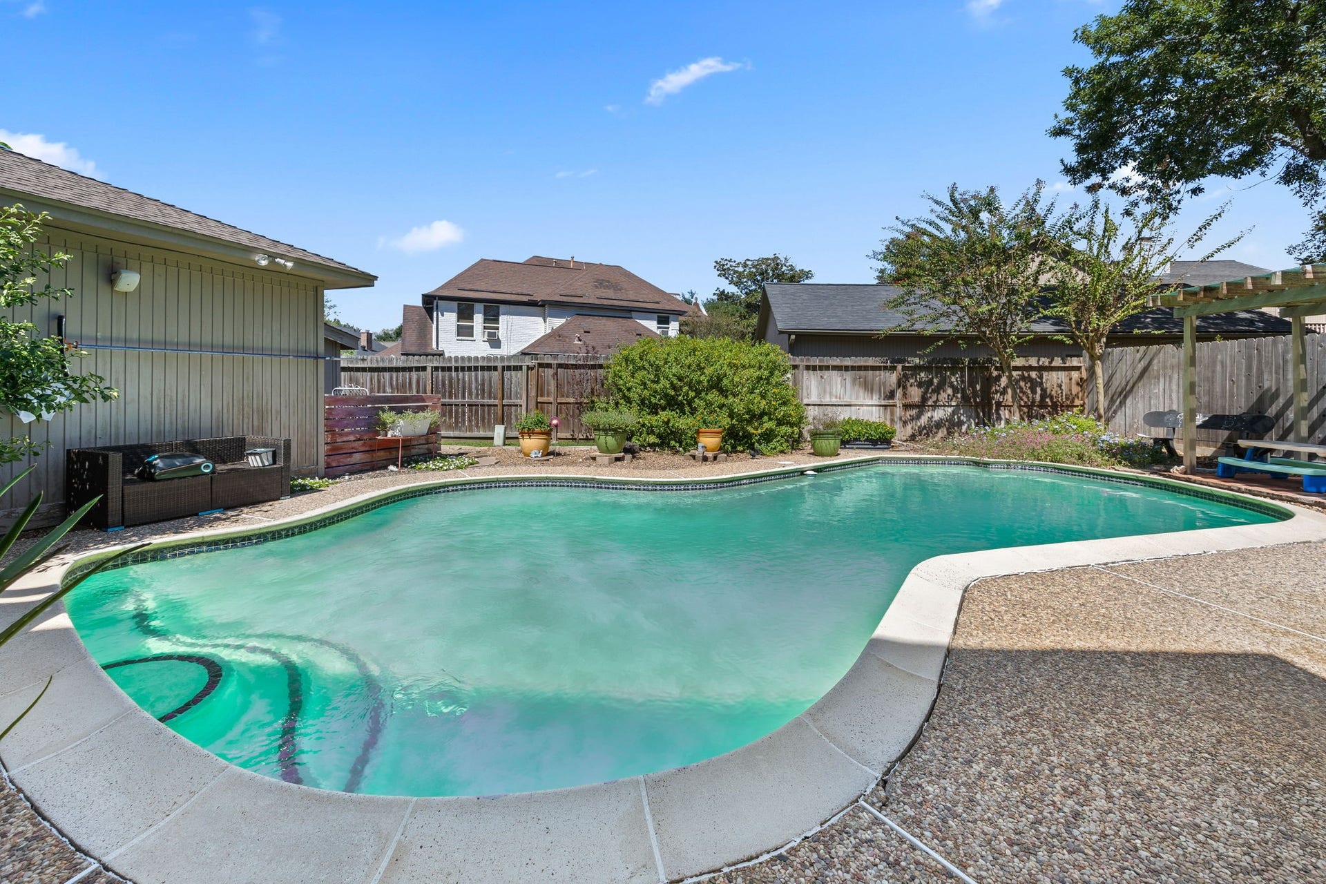 1622 Rambling Stone Drive, Richmond, TX 77406 Enjoy your own backyard retreat with a generously sized swimming pool, expansive decking for lounging and entertaining, and surrounding landscaping. Plenty of room to enjoy sunny afternoons, weekend gatherings, or a relaxing swim at home.