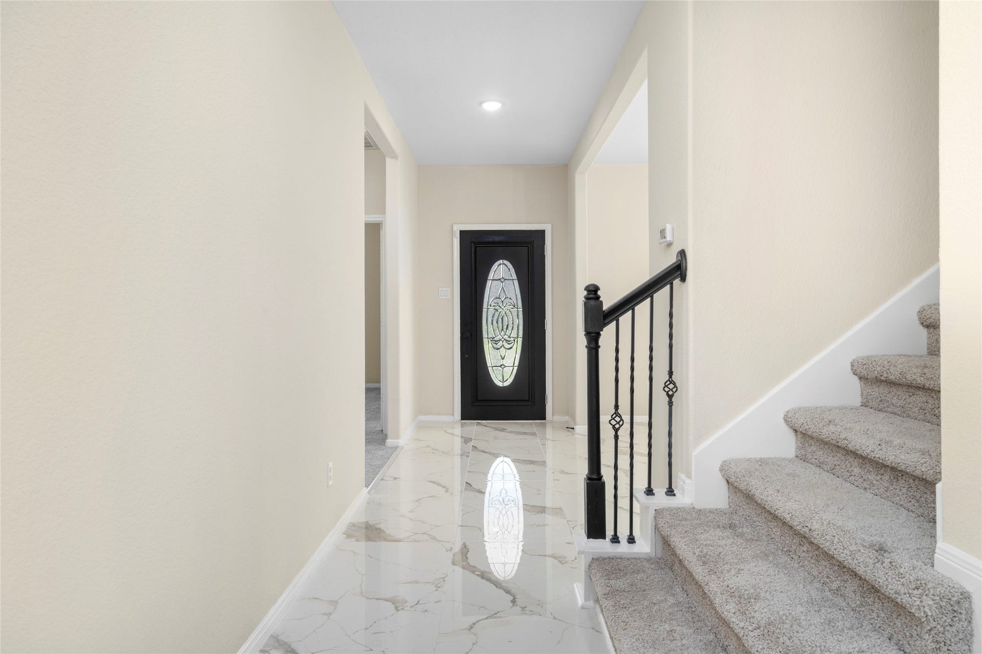 9423 Mineral Rock Lane, Richmond, TX 77407 Step inside to tile flooring underfoot and a wrought-iron staircase rising to the second floor an entrance built to impress.