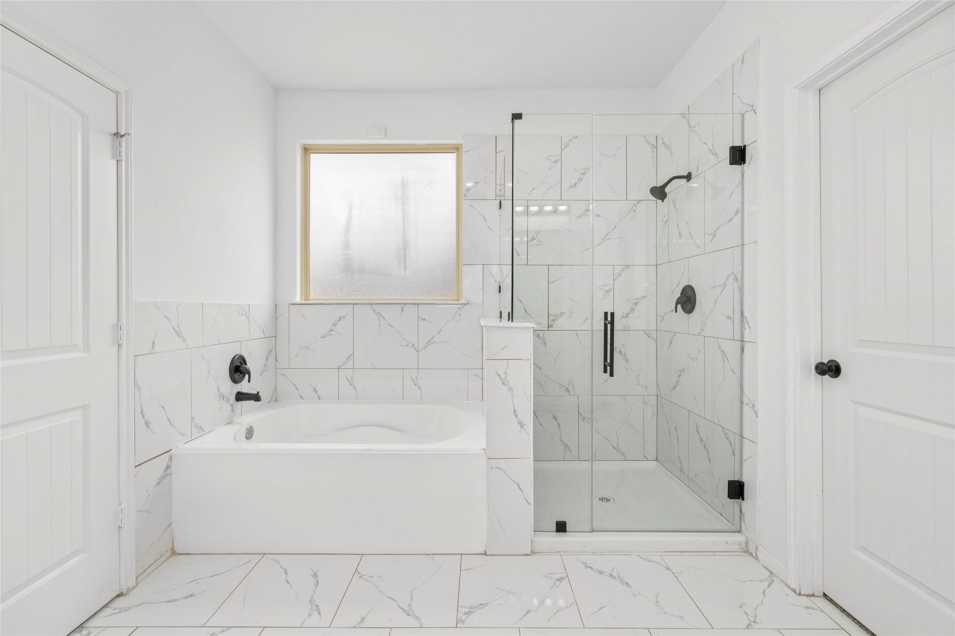 9423 Mineral Rock Lane, Richmond, TX 77407 A standalone soaking tub and separate glass shower make the primary bath feel like a personal spa.