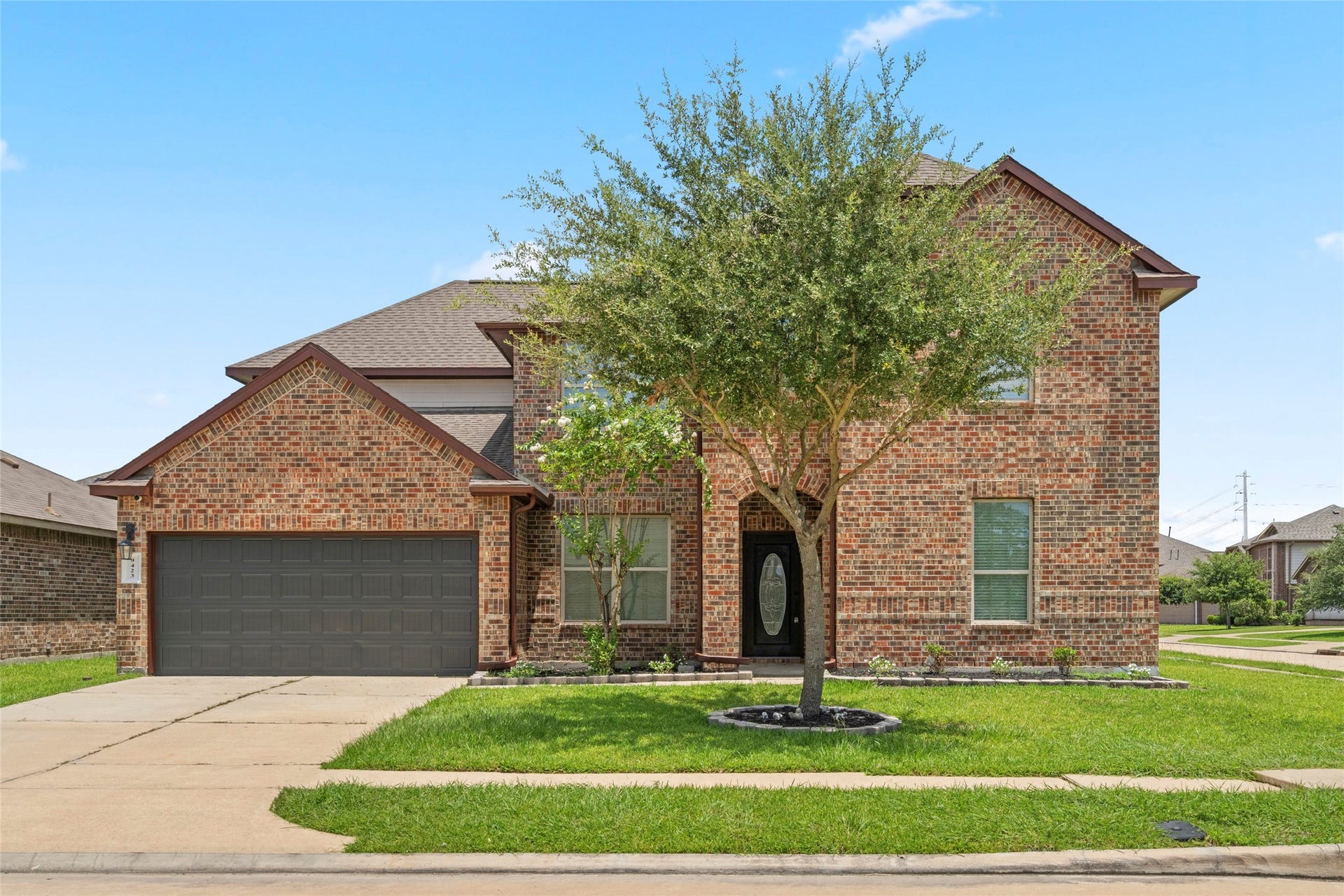 9423 Mineral Rock Lane, Richmond, TX 77407 A mature shade tree anchors the front yard, adding curb appeal and character to this classic brick facade.
