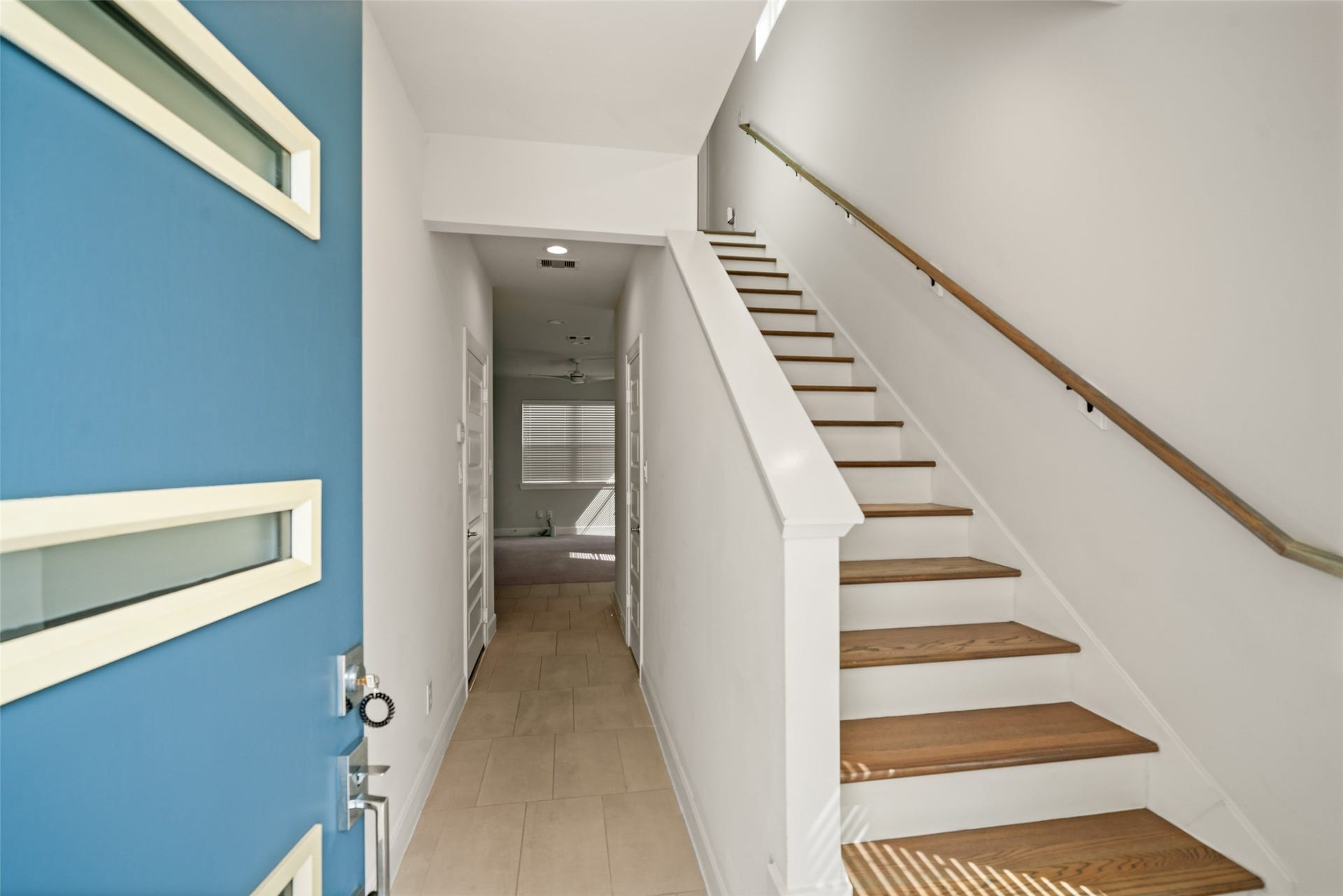 502 W Donovan Street, #A, Houston, TX 77091 Tile entry with wood stair treads. The hall leads to the downstairs bedroom, full bath, and den.
