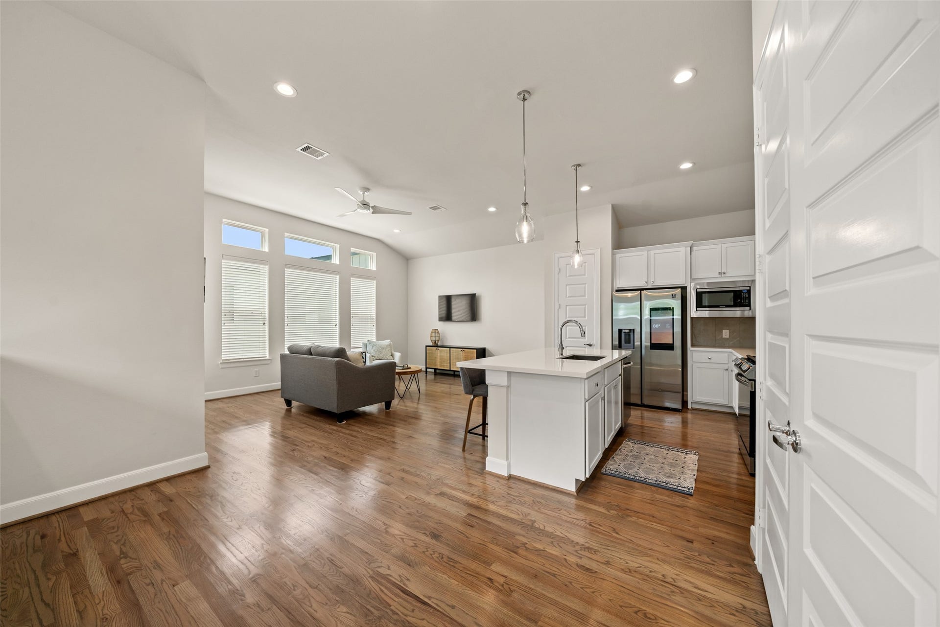 502 W Donovan Street, #A, Houston, TX 77091 At the top of the stairs, the second floor opens into one big living, dining, and kitchen space with wood floors and high ceilings.