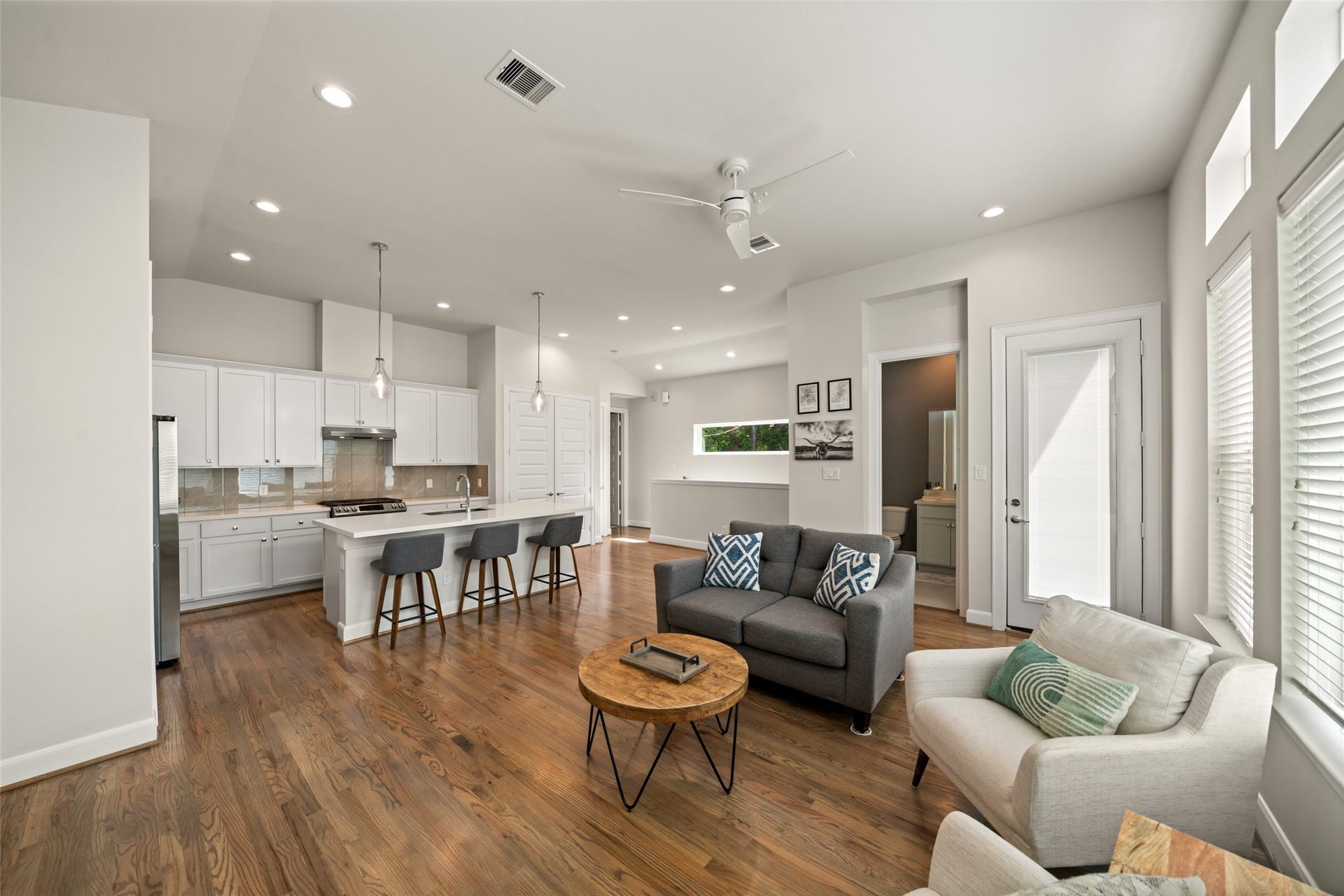 502 W Donovan Street, #A, Houston, TX 77091 Open-concept second floor. Kitchen, dining, and living share one bright room, with the half bath and balcony door just off the living area.