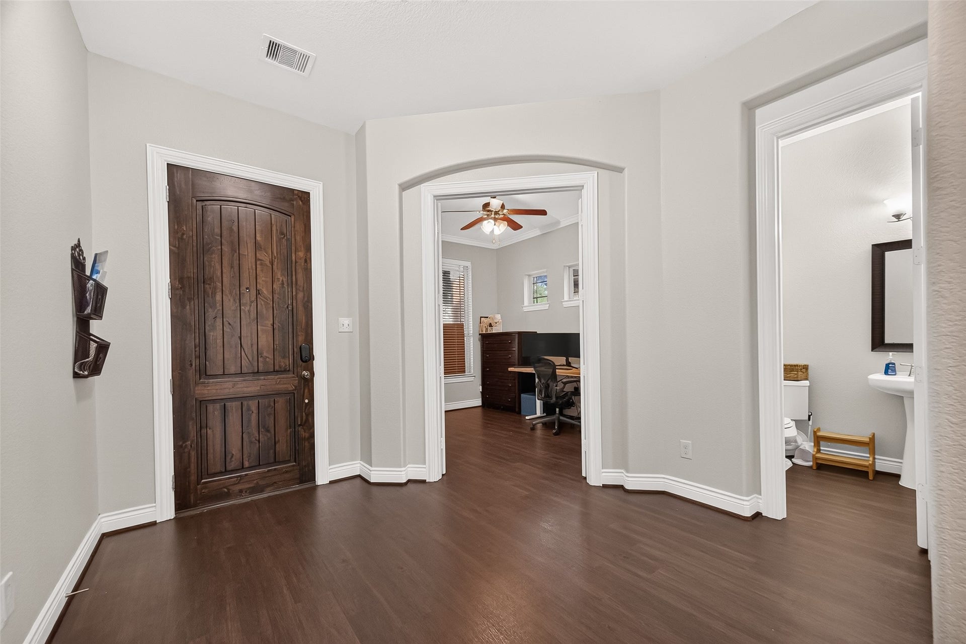 Entryway view to the office and half bath.