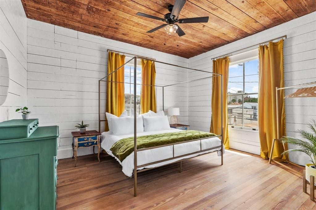 801 24th Street, Galveston, TX 77550 Bedroom one on the second floor. Hardwood Floors, stained ceiling and updated ceiling fan. Large windows letting in natural light