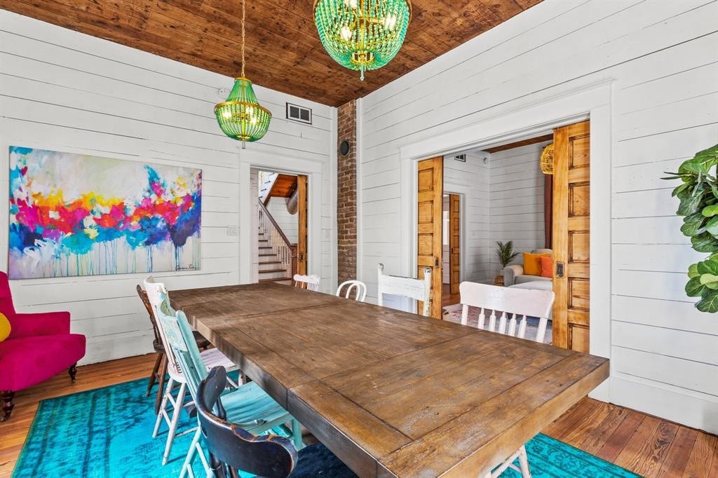 801 24th Street, Galveston, TX 77550 Dining room with stained wood ceiling accent, pocket doors, brick wall exposure