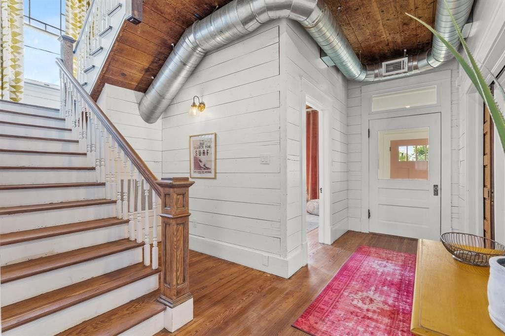 801 24th Street, Galveston, TX 77550 Stairs at the entryway featuring beautiful hardwood floors.