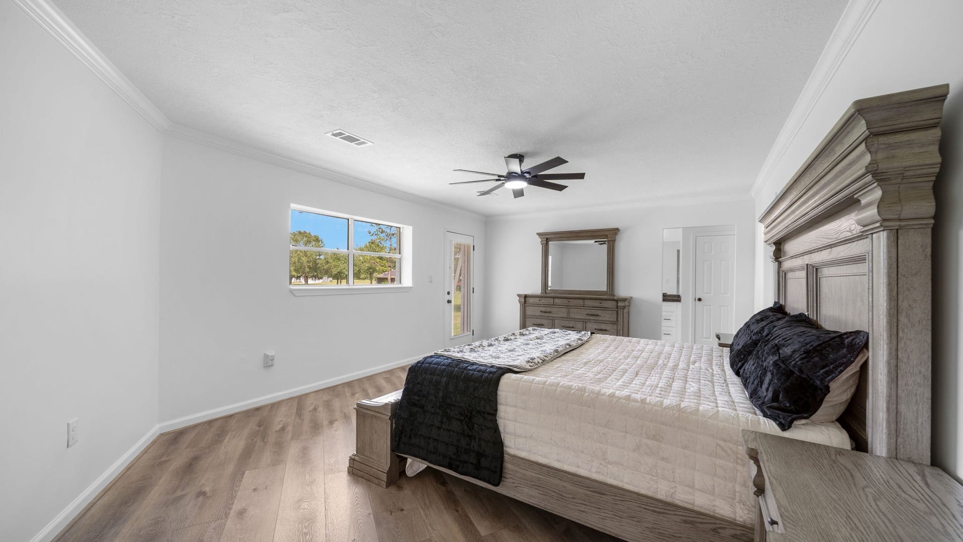 15502 Kitty Hawk Drive, Waller, TX 77484 Primary bedroom is large with plenty of room for large furniture exterior door leads to a nice size deck