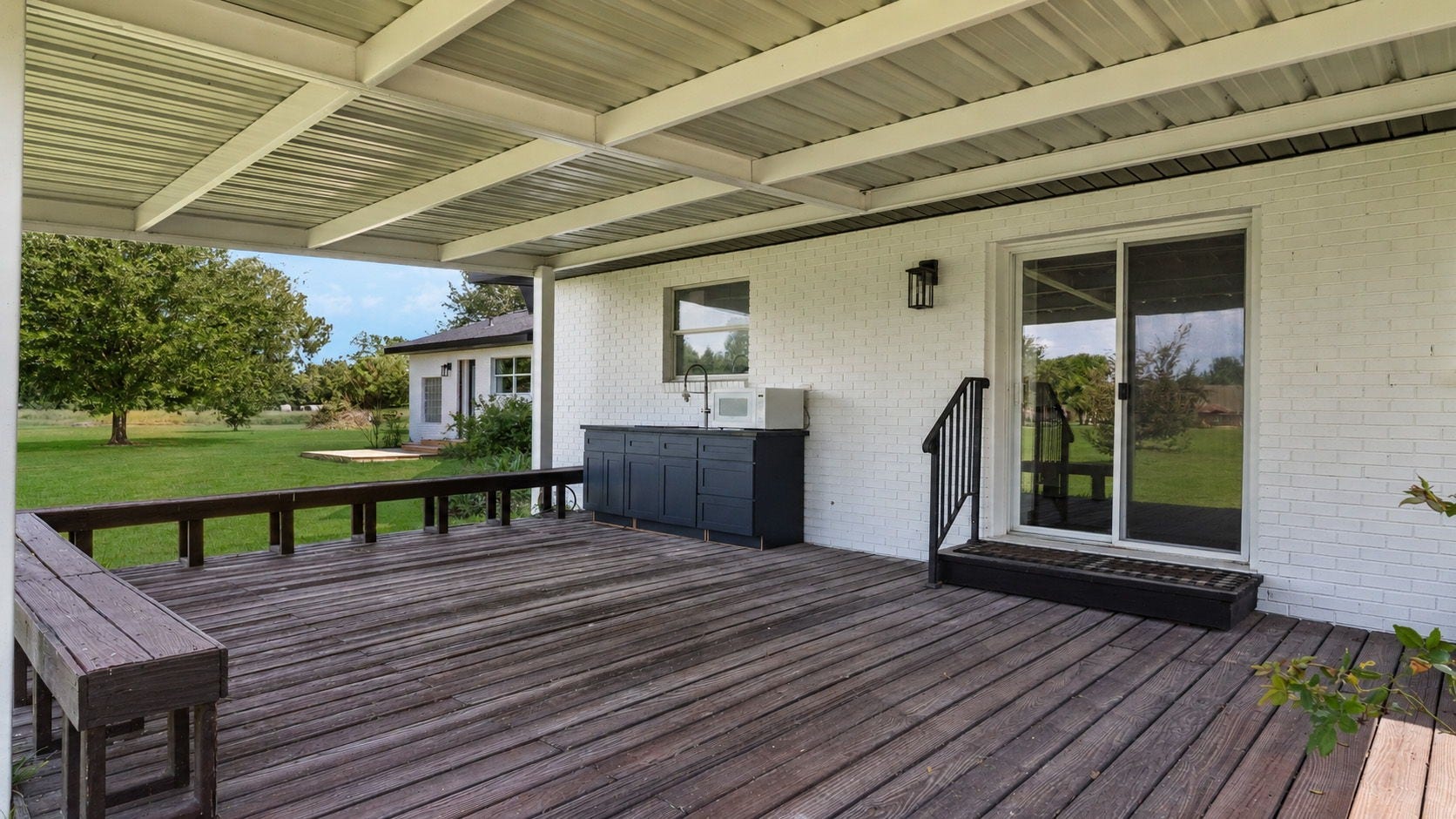 15502 Kitty Hawk Drive, Waller, TX 77484 Over sized Covered porch with cabinets, hot and cold water, large deep farm sink