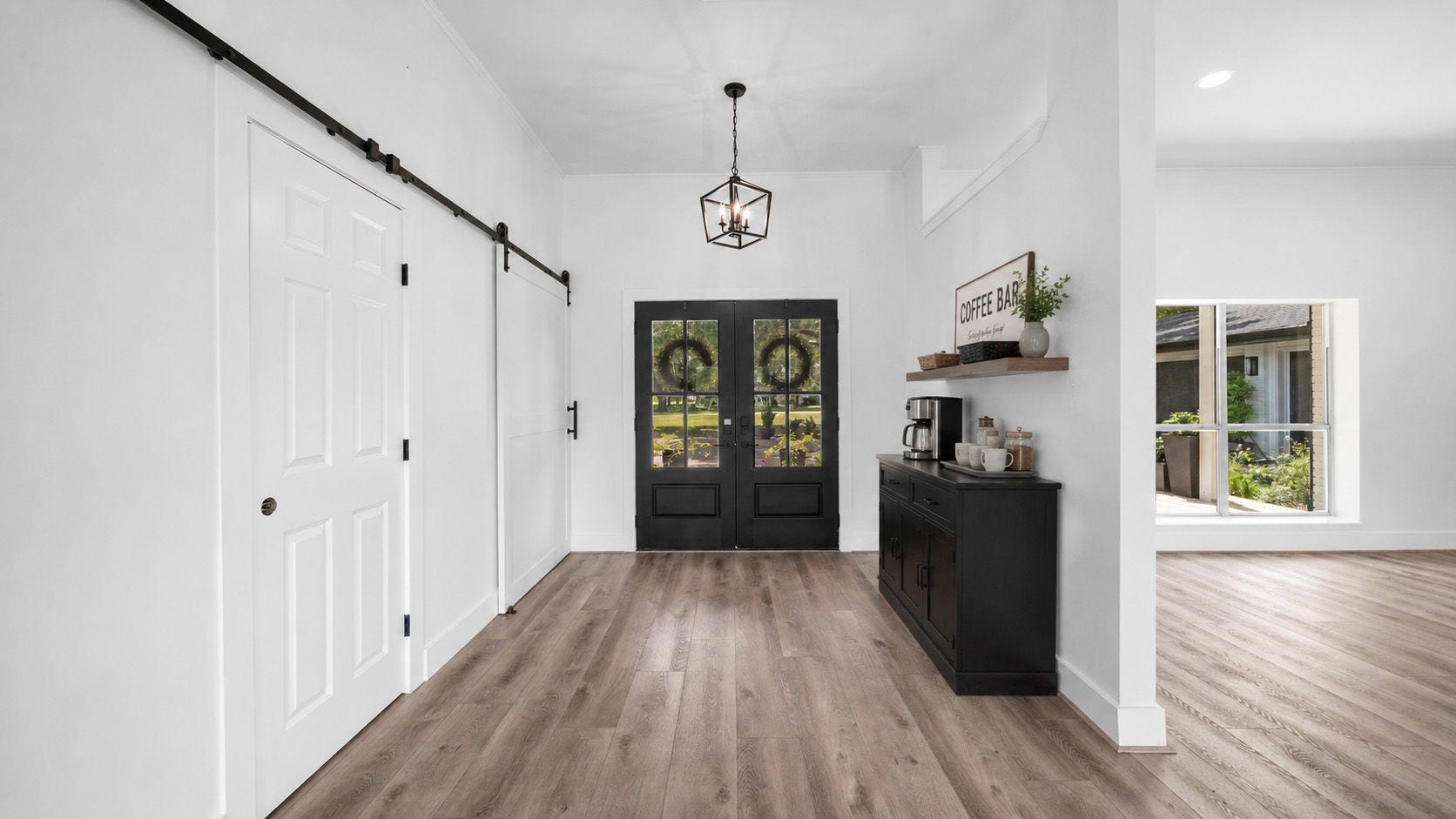 15502 Kitty Hawk Drive, Waller, TX 77484 Staged entry Barn doors lead to hallway to Primary bedroom and hallway to 2 of the secondary bedrooms, bath and linen closet