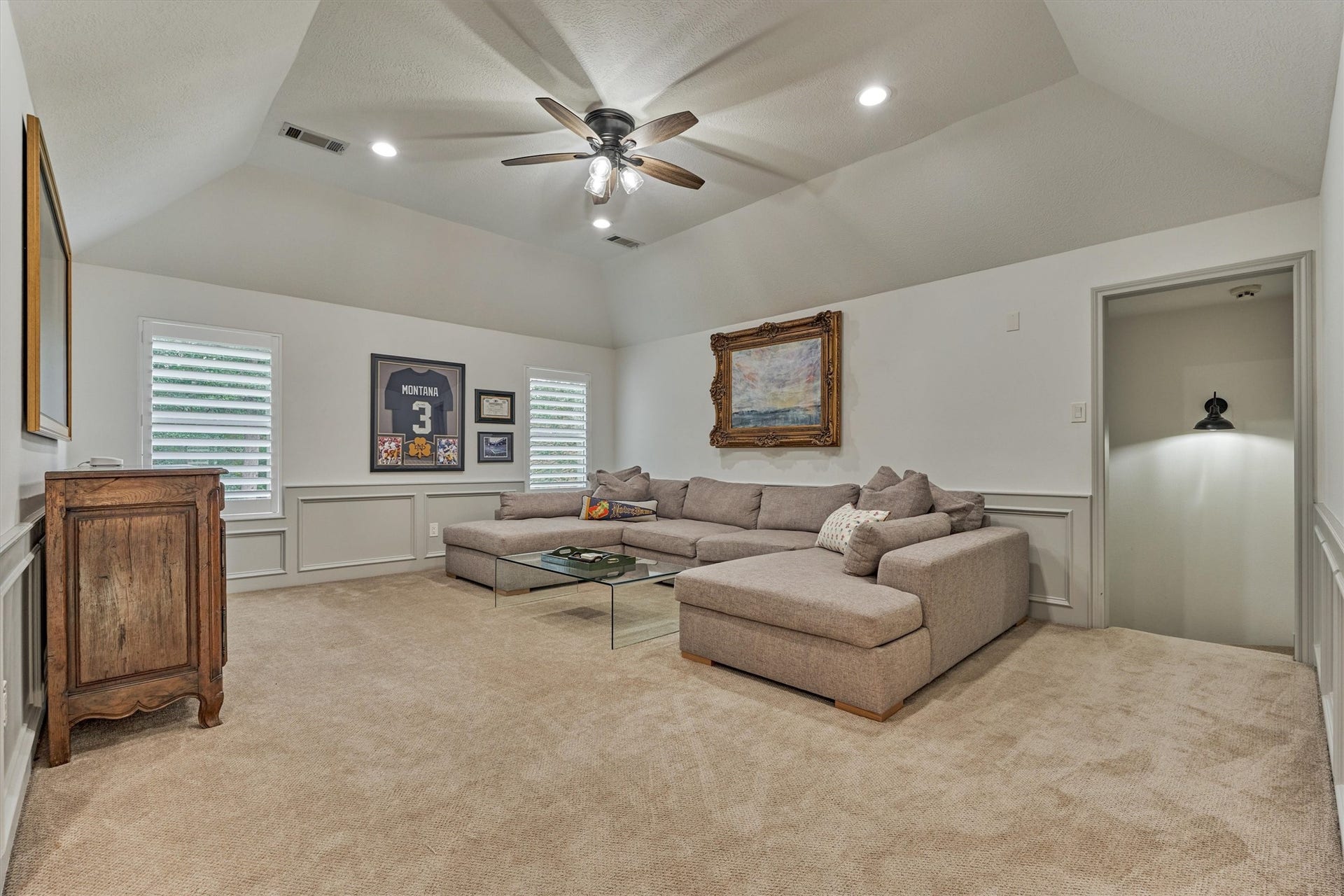 42 Golden Shadow Circle, The Woodlands, TX 77381 An elevated game room showcases custom wall paneling and an abundance of space for entertaining.