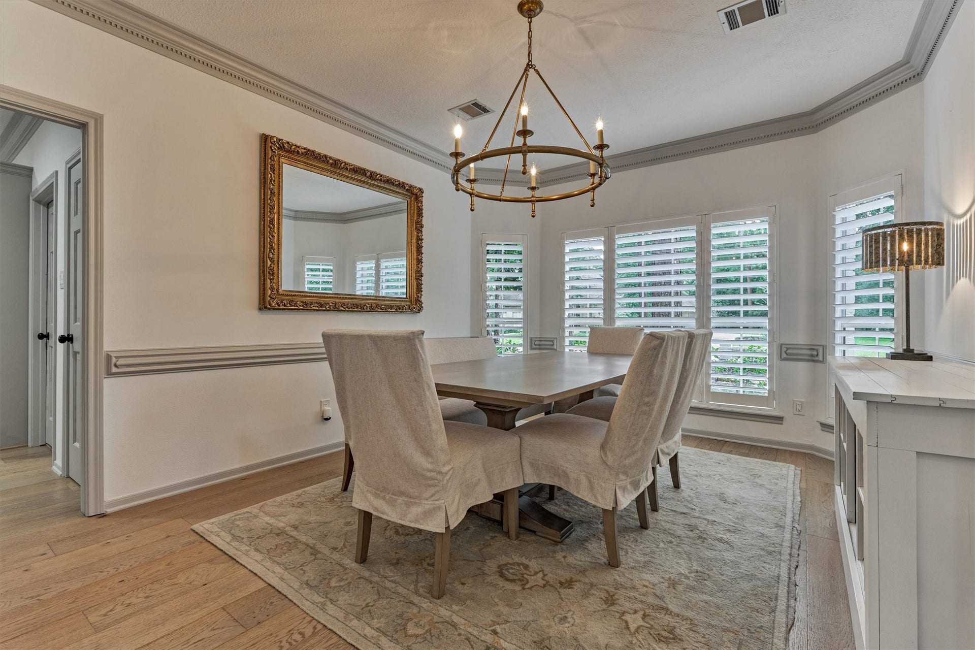 42 Golden Shadow Circle, The Woodlands, TX 77381 Striking formal dining room showcases custom moldings and windows with views of the front yard. Plantation shutters run throughout this completely updated home!
