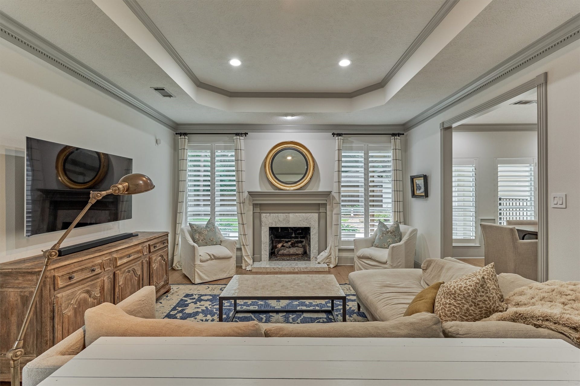 42 Golden Shadow Circle, The Woodlands, TX 77381 Architectural details shine in the den, where a beautiful tray ceiling and windows frame views of the private backyard retreat.