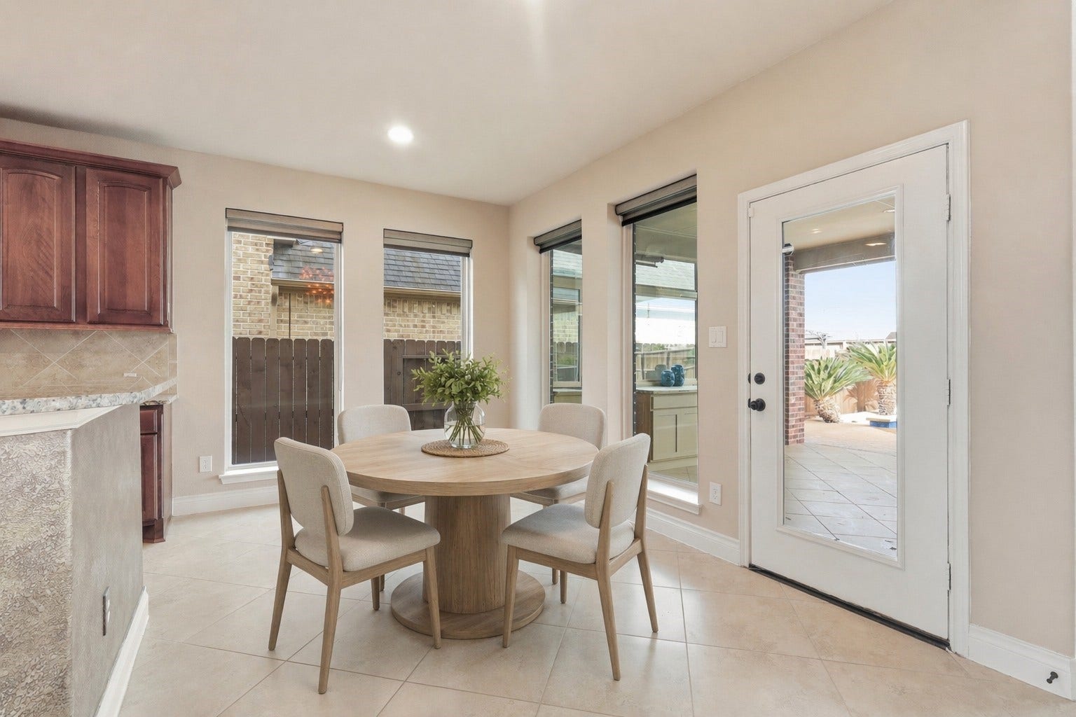 4130 Clover Ridge Lane, Sugar Land, TX 77479 Bright dining area with tiled flooring, large windows and a glass door offer natural light and a view of the patio for indoor/otdoor living.