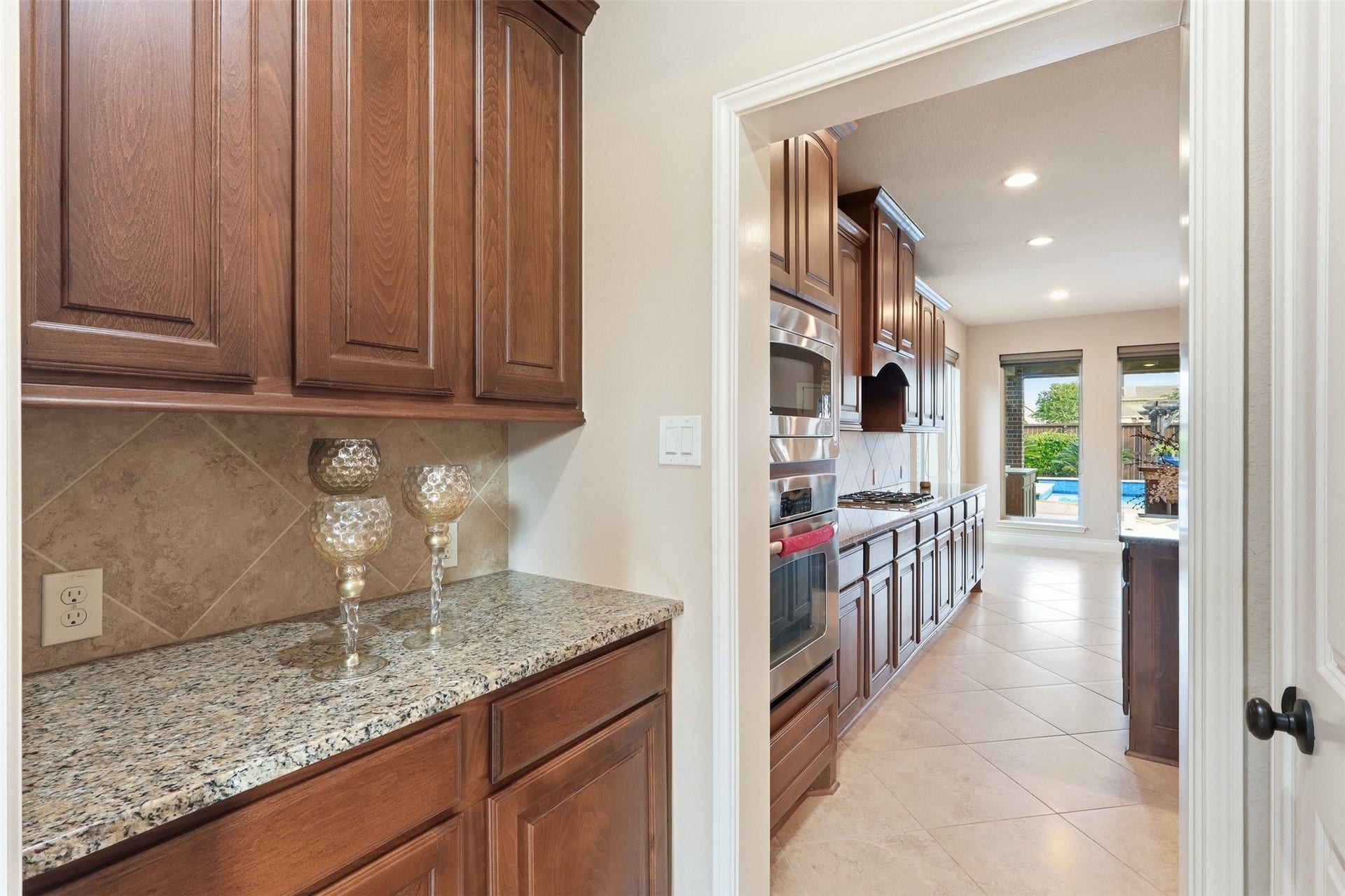 4130 Clover Ridge Lane, Sugar Land, TX 77479 Butler's pantry for extra storage of dishes and utensils.