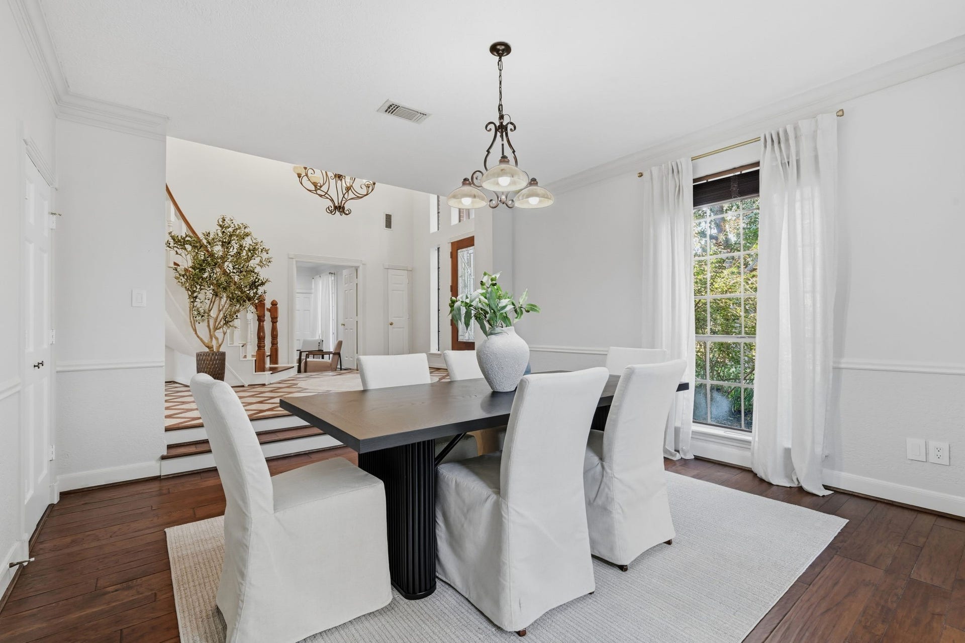 The elegant formal dining room is filled with natural light from tall windows framing picturesque outdoor views. Conveniently located with easy access to the kitchen, this beautifully appointed space offers a wonderful setting for holiday celebrations & intimate dinner parties.