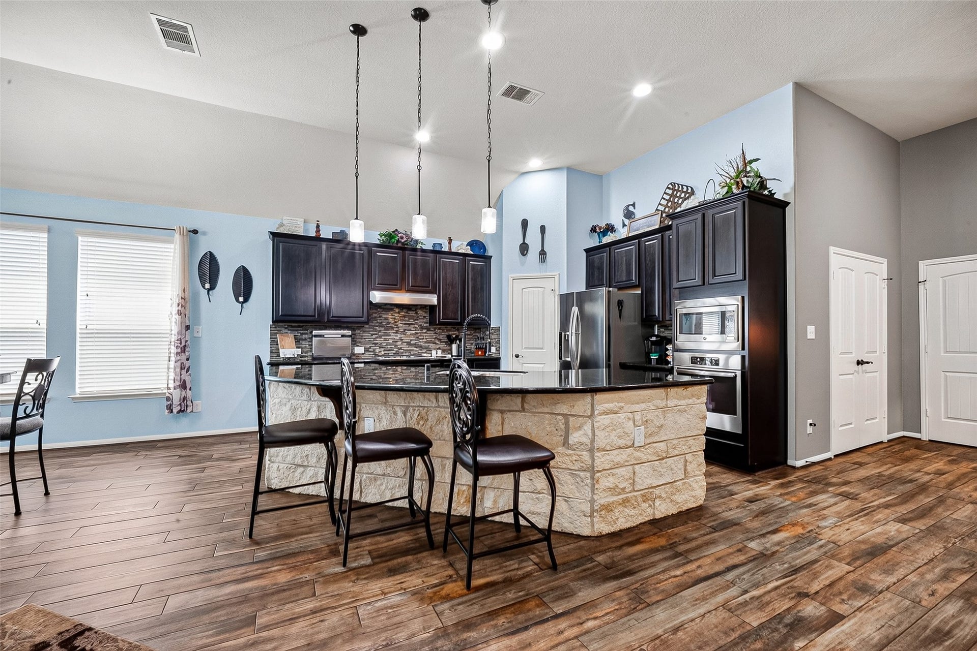2414 Alexandra, Deer Park, TX 77536 Beautiful Wood Grain Porcelain Title Flows Throughout The Main Living Areas, Complemented By Sleek Granite Countertops In The Kitchen For a Refined, Upscale Finishs