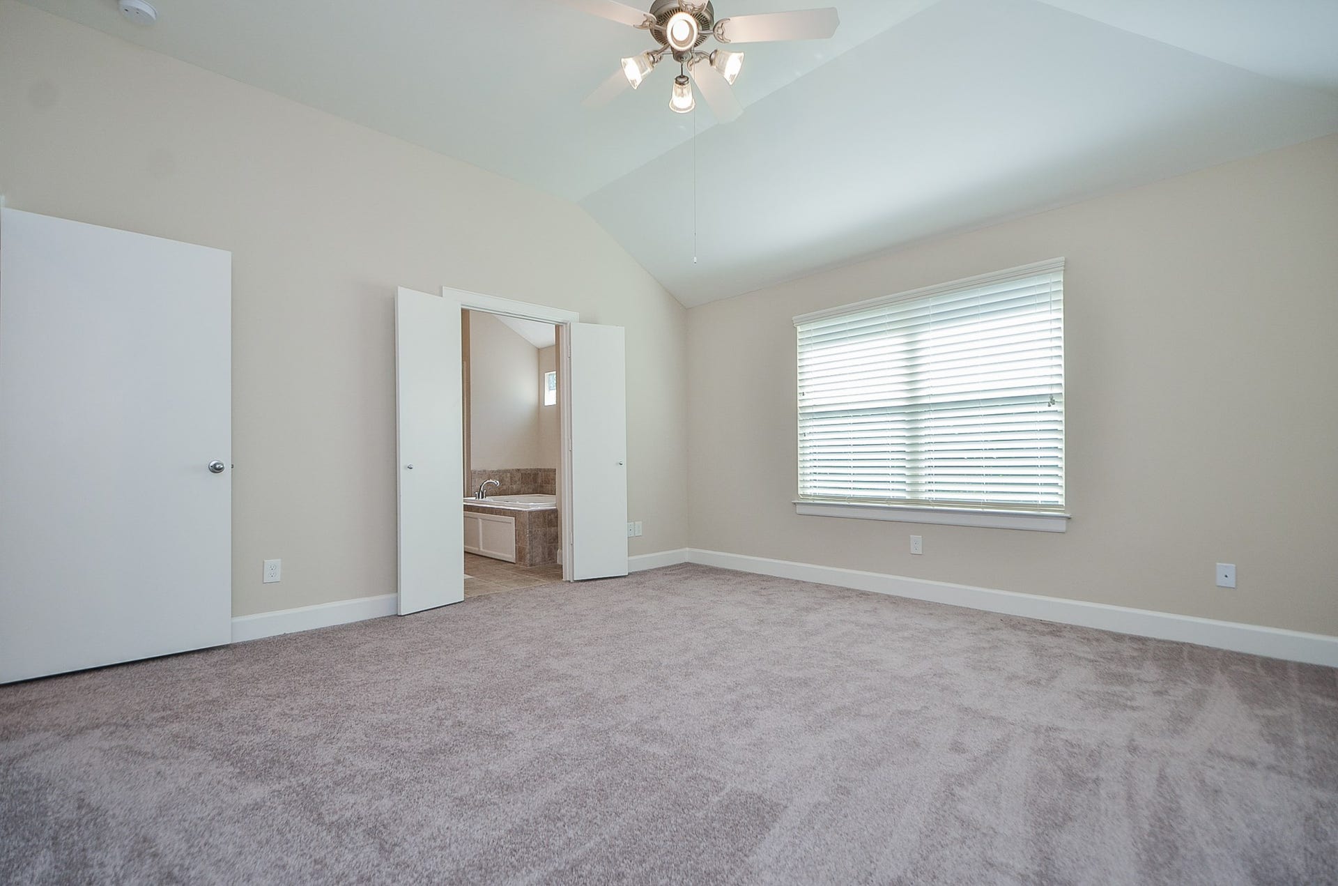 924 E 39th Street, Houston, TX 77022 The master bedroom has plush carpet, hight ceilings, a ceiling fan, pre-installed blinds, and plenty of natural light.