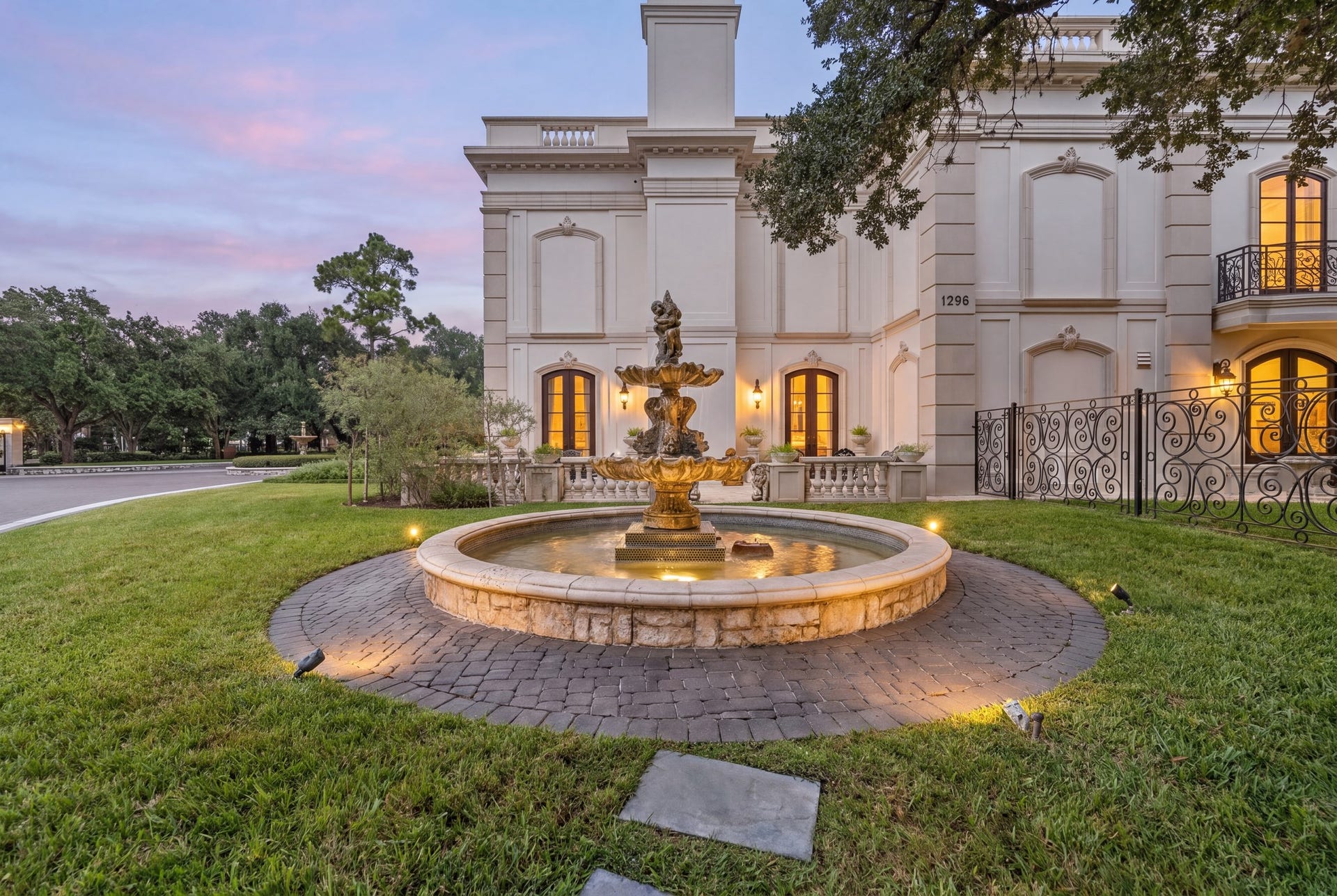 2115 River Oaks Boulevard, Houston, TX 77019 A second tiered fountain anchors the garden beside the residence, surrounded by lawn and established trees.