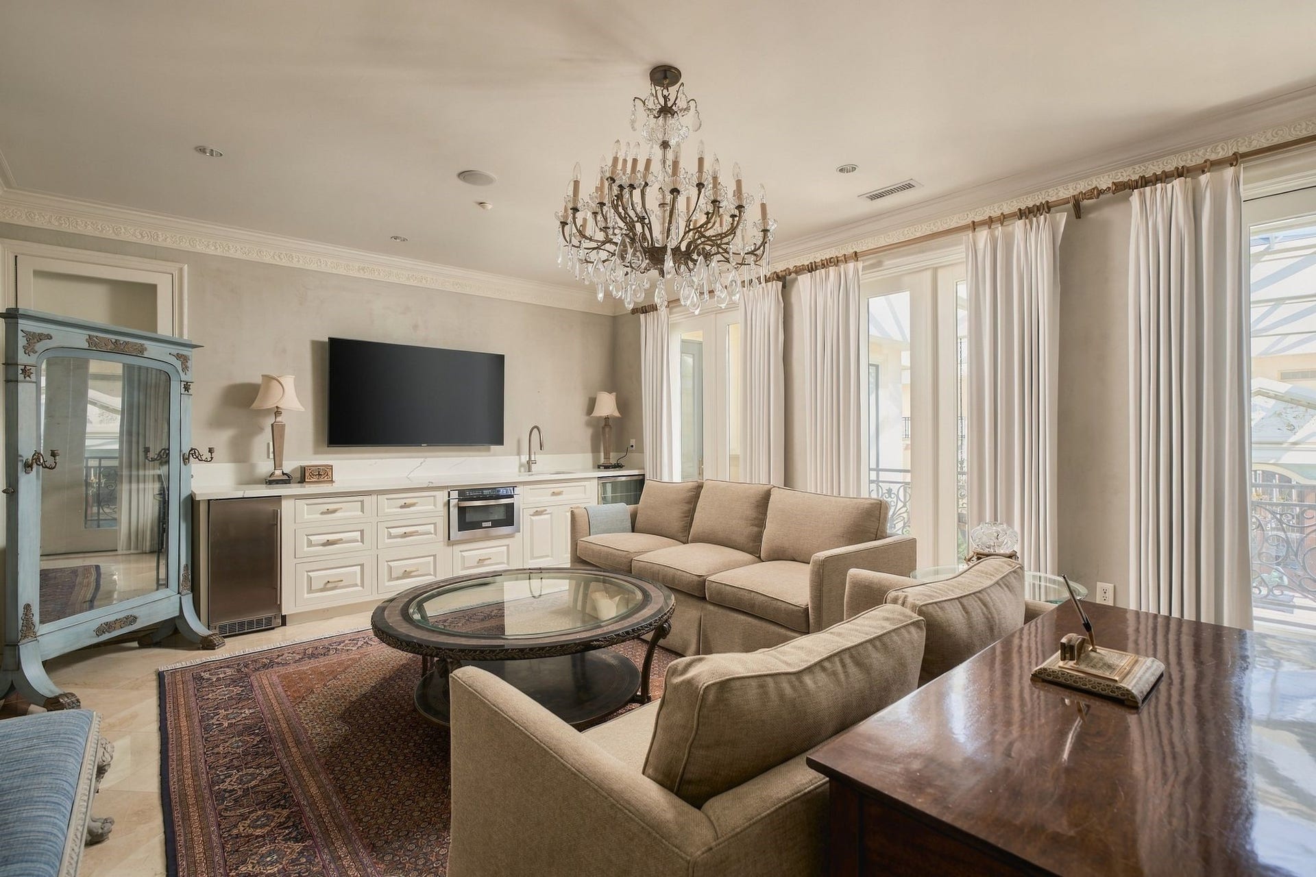 2115 River Oaks Boulevard, Houston, TX 77019 The primary sitting room features built-in cabinetry and glass doors overlooking the atrium.