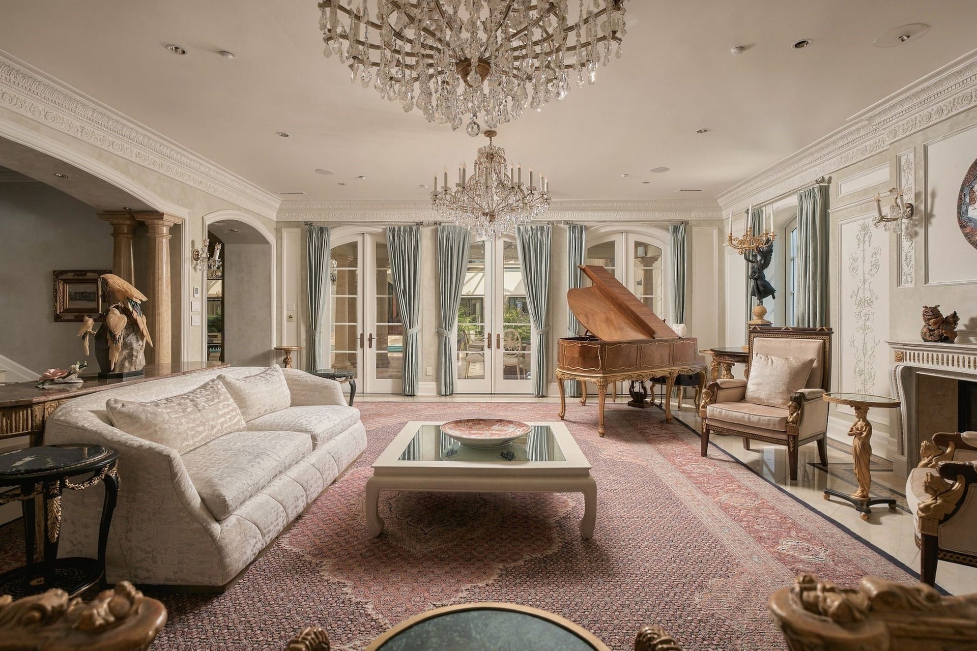 2115 River Oaks Boulevard, Houston, TX 77019 Detail crown molding, updated bright windows, and gas fireplace create an elegant setting for the formal living room.