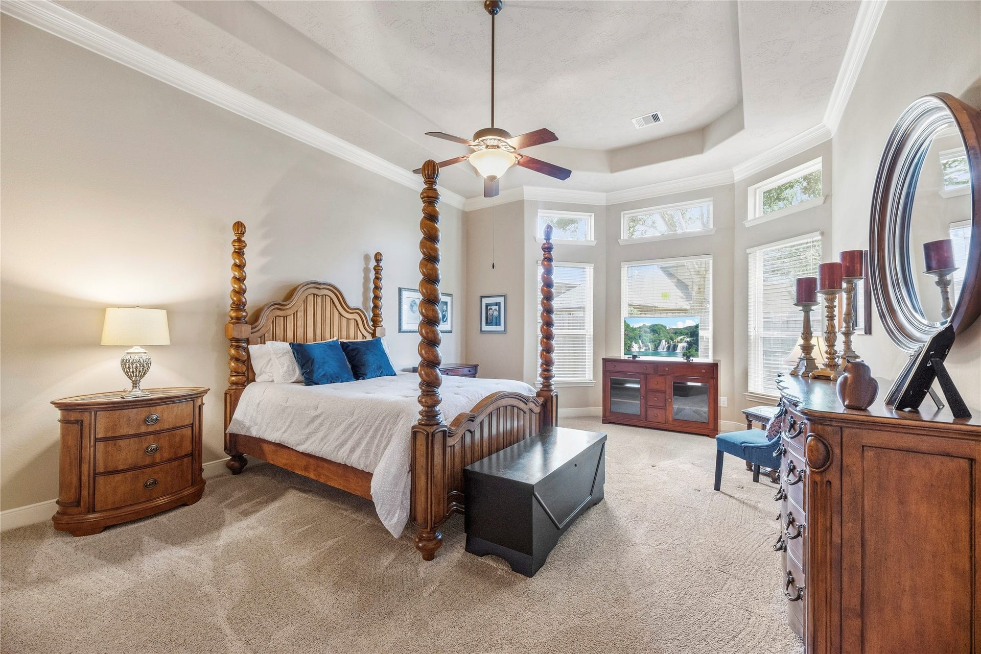 8623 Crescent Spur Drive, Richmond, TX 77406 Retreat to the spacious primary suite, featuring a tray ceiling, a bay of windows and room for a cozy sitting area.