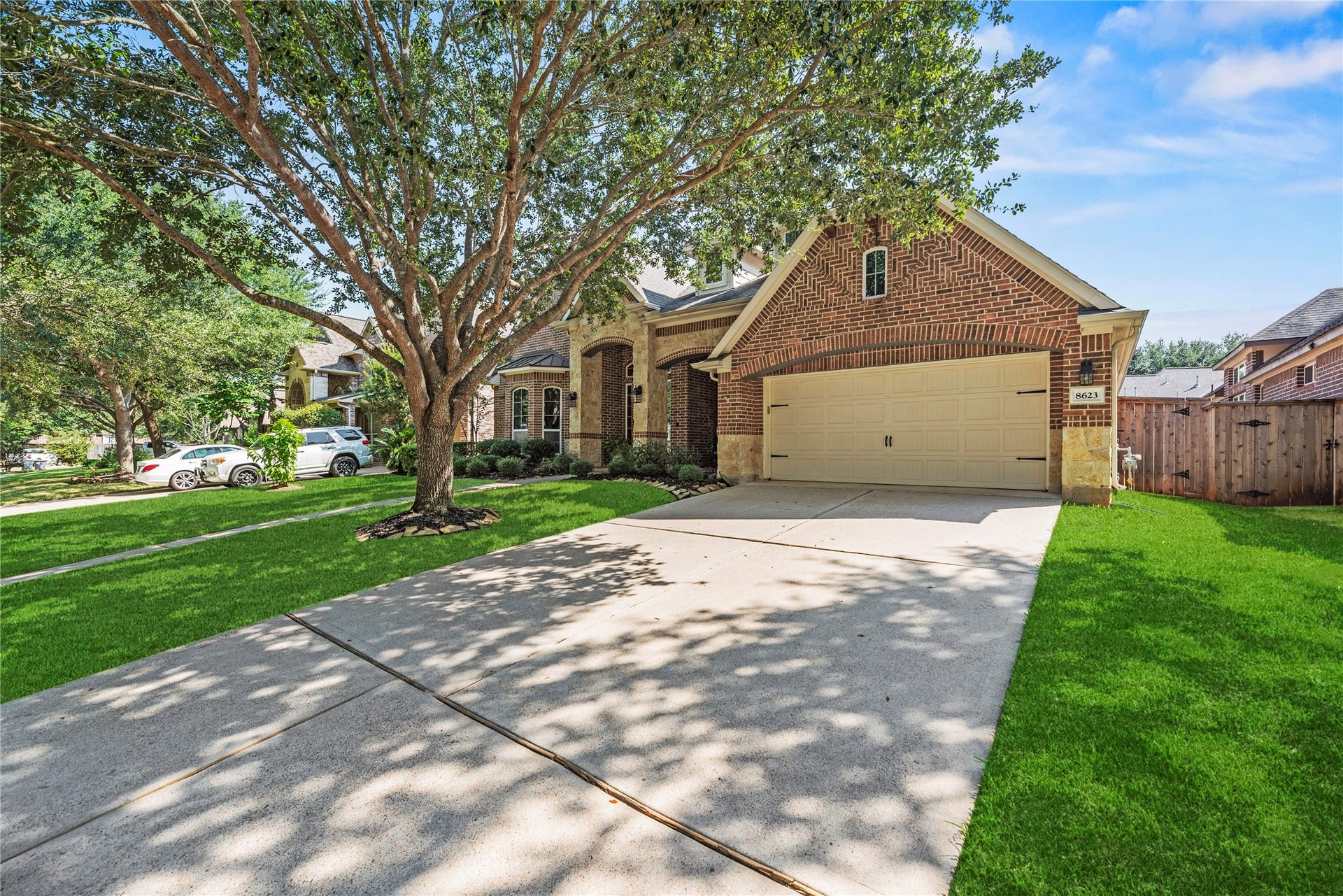 8623 Crescent Spur Drive, Richmond, TX 77406 A wide driveway and attached garage provide ample parking and everyday convenience.