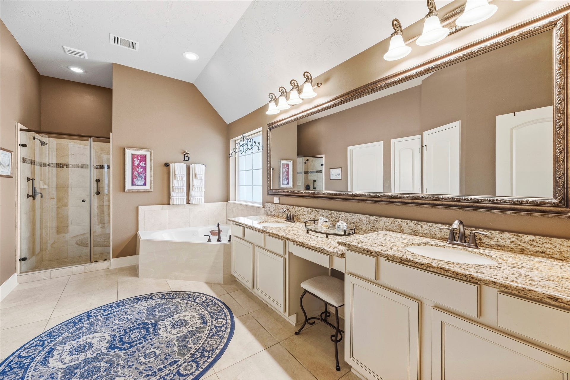 8623 Crescent Spur Drive, Richmond, TX 77406 The spa inspired primary bath offers dual vanities, a walk in shower and generous storage for a relaxing daily routine.