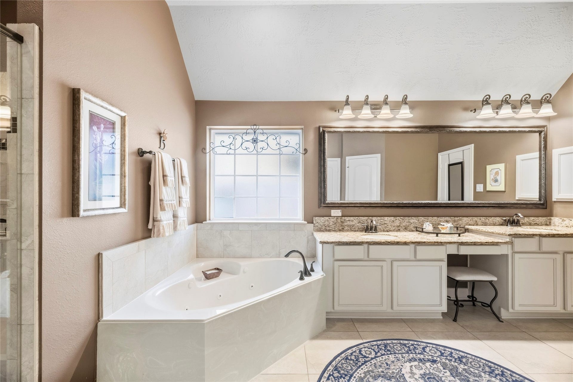 8623 Crescent Spur Drive, Richmond, TX 77406 Unwind in the soaking tub, bathed in natural light, with an expansive vanity close at hand.