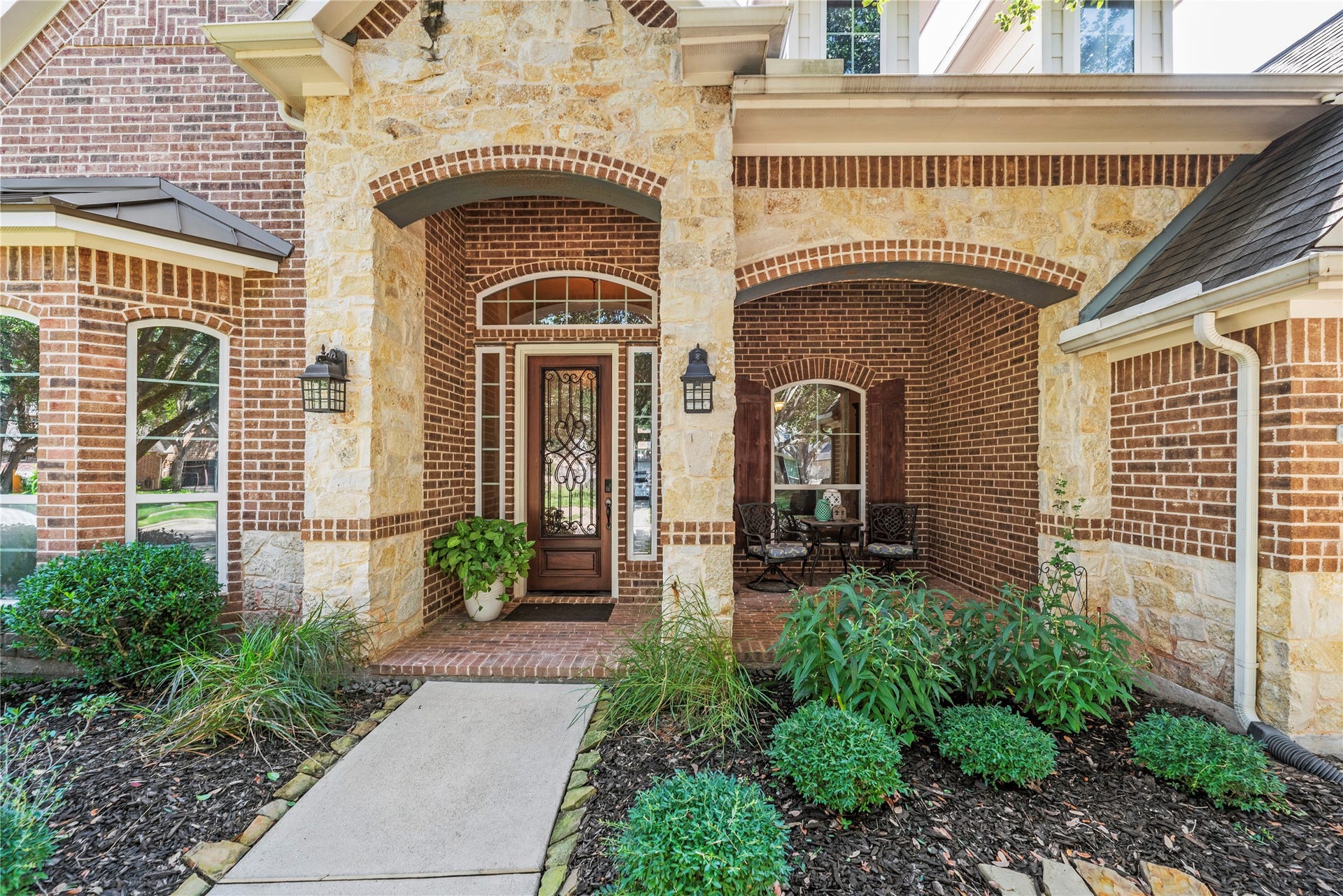 8623 Crescent Spur Drive, Richmond, TX 77406 A gracious covered entry with arched detailing and lush landscaping sets an elegant tone before you ever step inside.