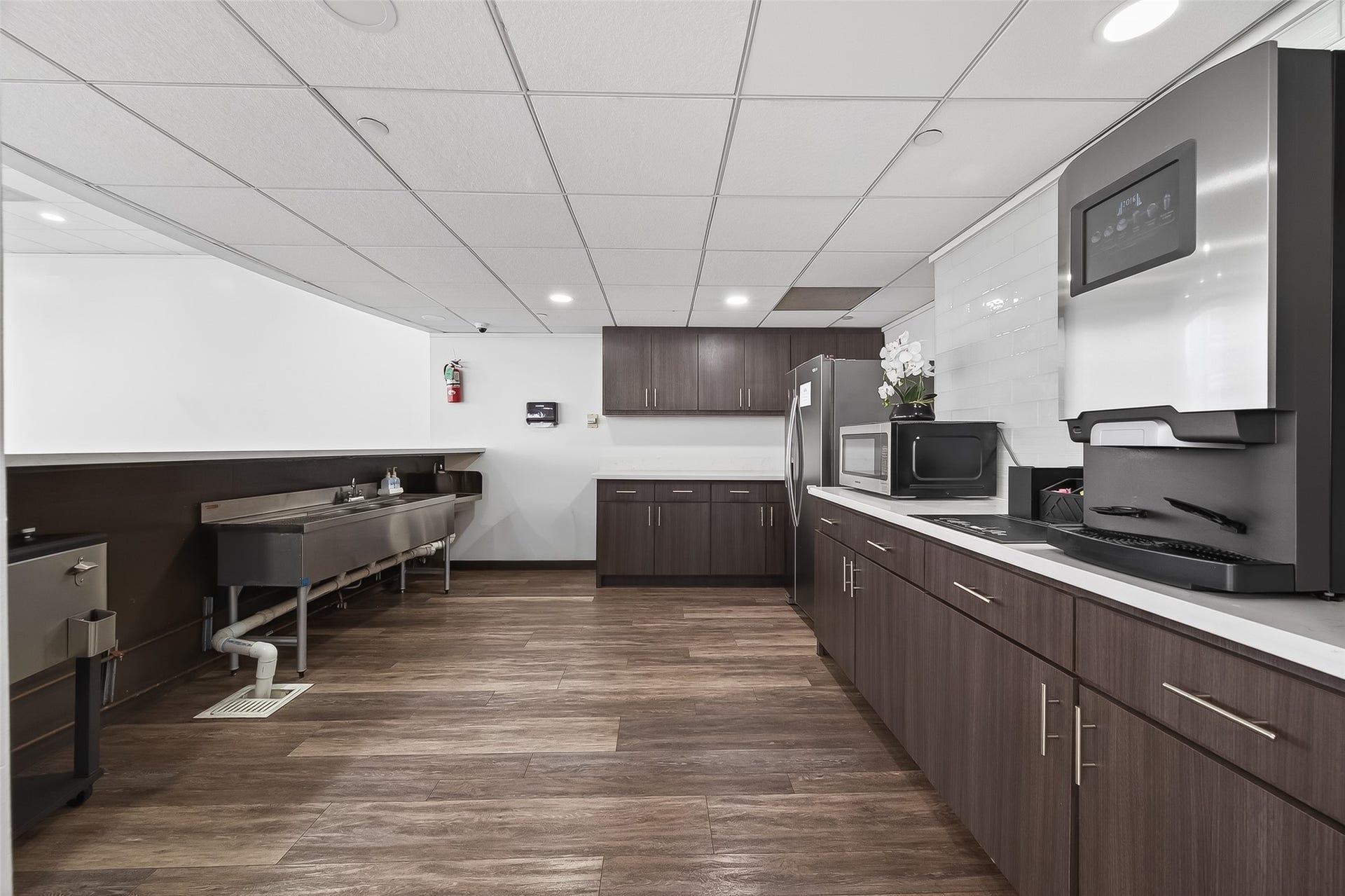 2016 Main Street, #PH 3, Houston, TX 77002 Modern kitchen with sleek dark wood cabinetry, stainless steel appliances, and ample counter space, perfect for culinary enthusiasts.