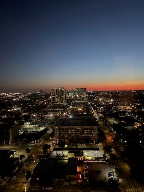 2016 Main Street, #PH 3, Houston, TX 77002 Experience breathtaking cityscape views at dusk, showcasing a vibrant urban skyline against a serene twilight sky.