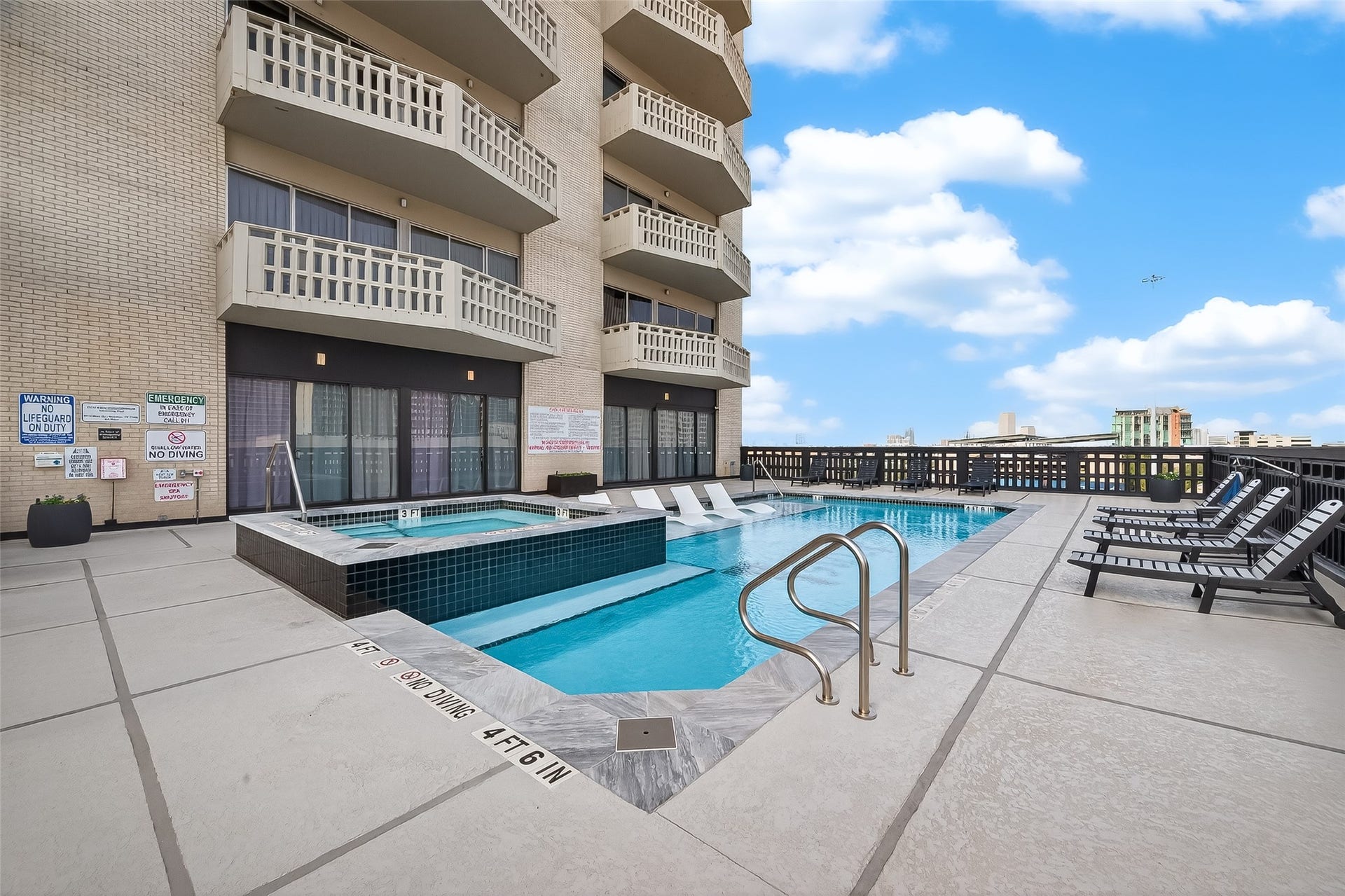 2016 Main Street, #PH 3, Houston, TX 77002 Stylish rooftop pool area with ample lounge seating, perfect for relaxation and enjoying panoramic city views.