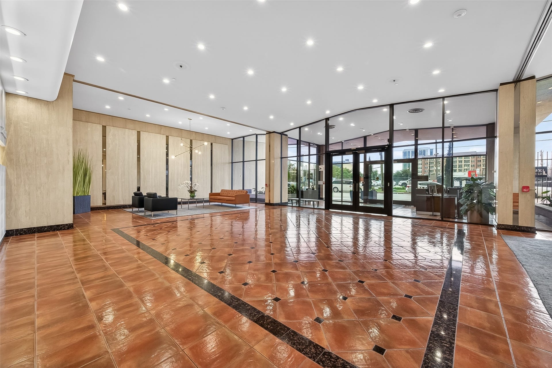 2016 Main Street, #PH 3, Houston, TX 77002 Spacious and elegant lobby with glossy tiled flooring, modern seating areas, and expansive floor-to-ceiling windows offering abundant natural light.