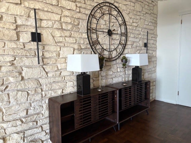 2016 Main Street, #PH 3, Houston, TX 77002 Chic entryway featuring a striking stone accent wall, elegant modern sconces, and a stylish console with contemporary lamps, creating a welcoming and sophisticated atmosphere.
