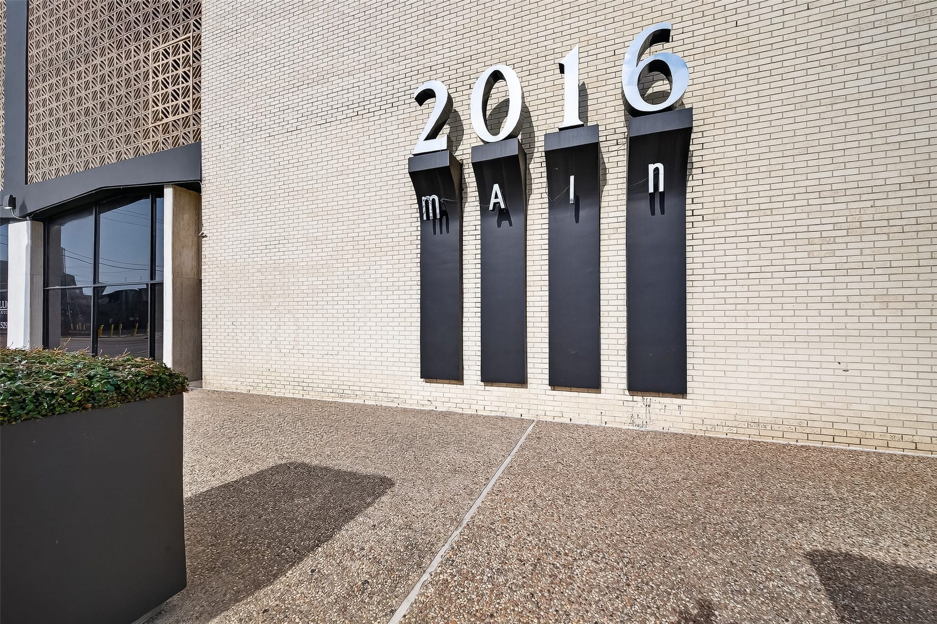 2016 Main Street, #PH 3, Houston, TX 77002 Modern building exterior with prominent street address signage and contemporary architectural details, offering a stylish urban vibe.