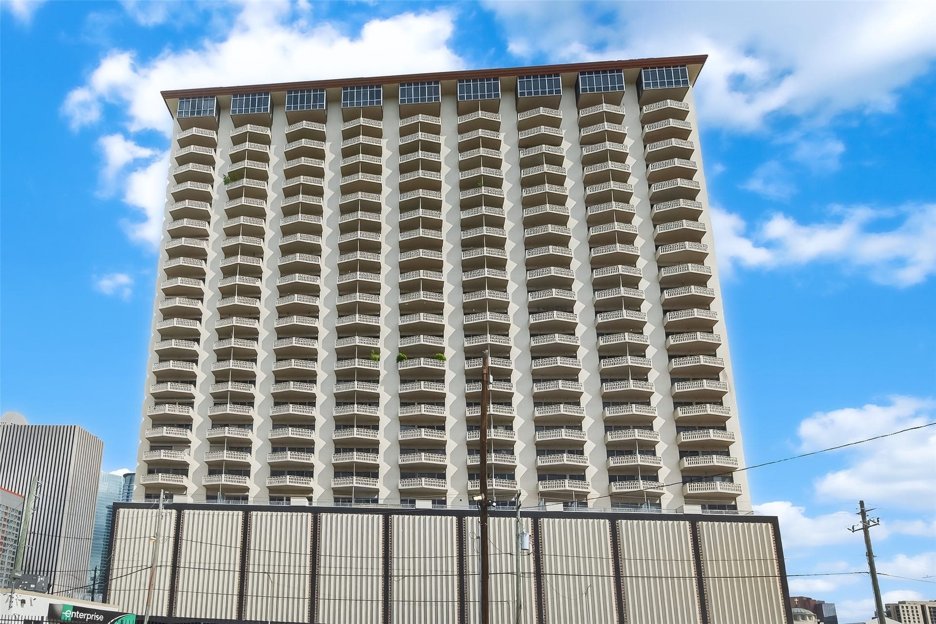 2016 Main Street, #PH 3, Houston, TX 77002 Stunning high-rise building featuring distinctive balcony designs, offering panoramic city views and modern urban living.