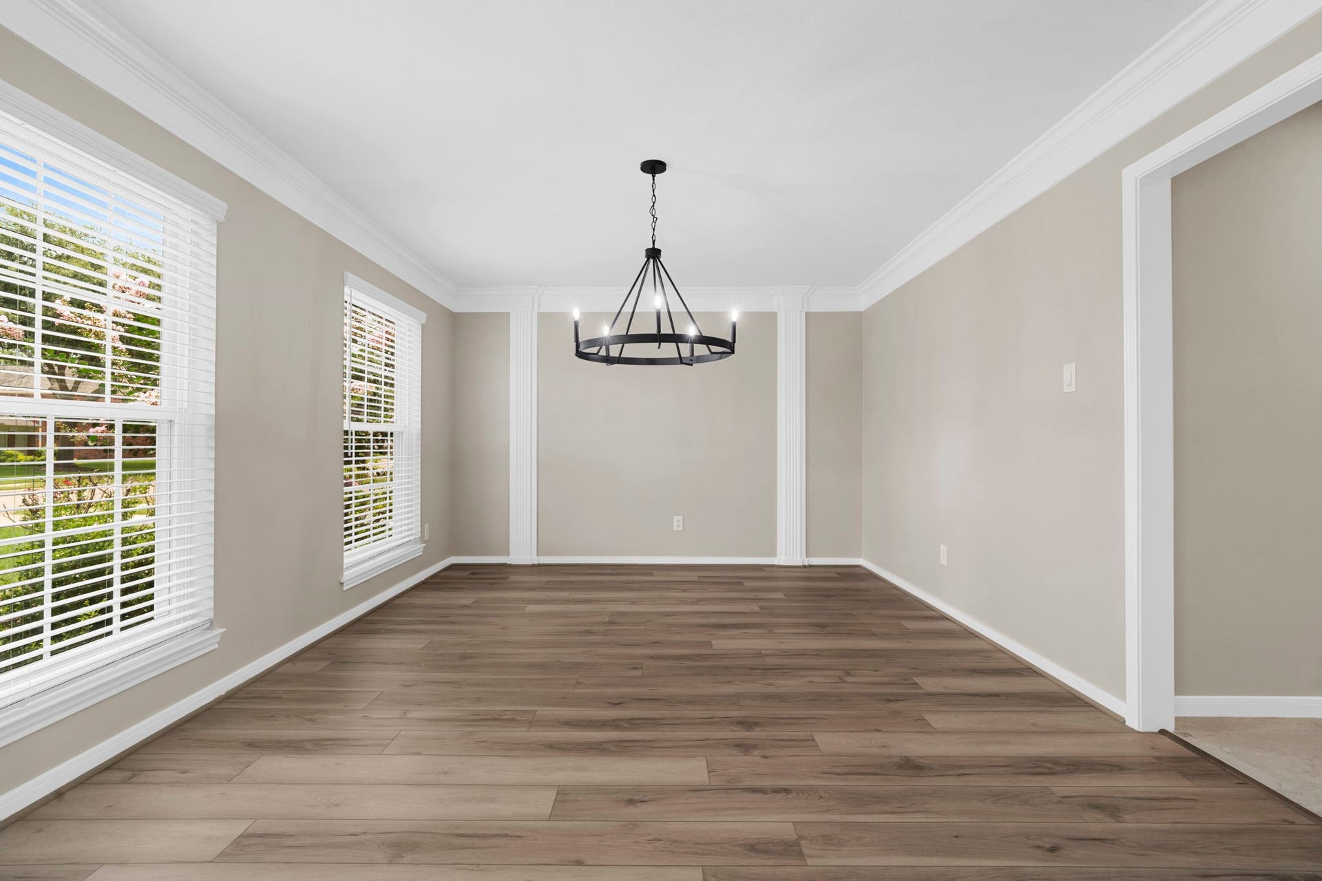 The formal dining room is framed by elegant millwork & abundant natural light. The spacious layout easily accommodates both intimate dinners & larger gatherings.