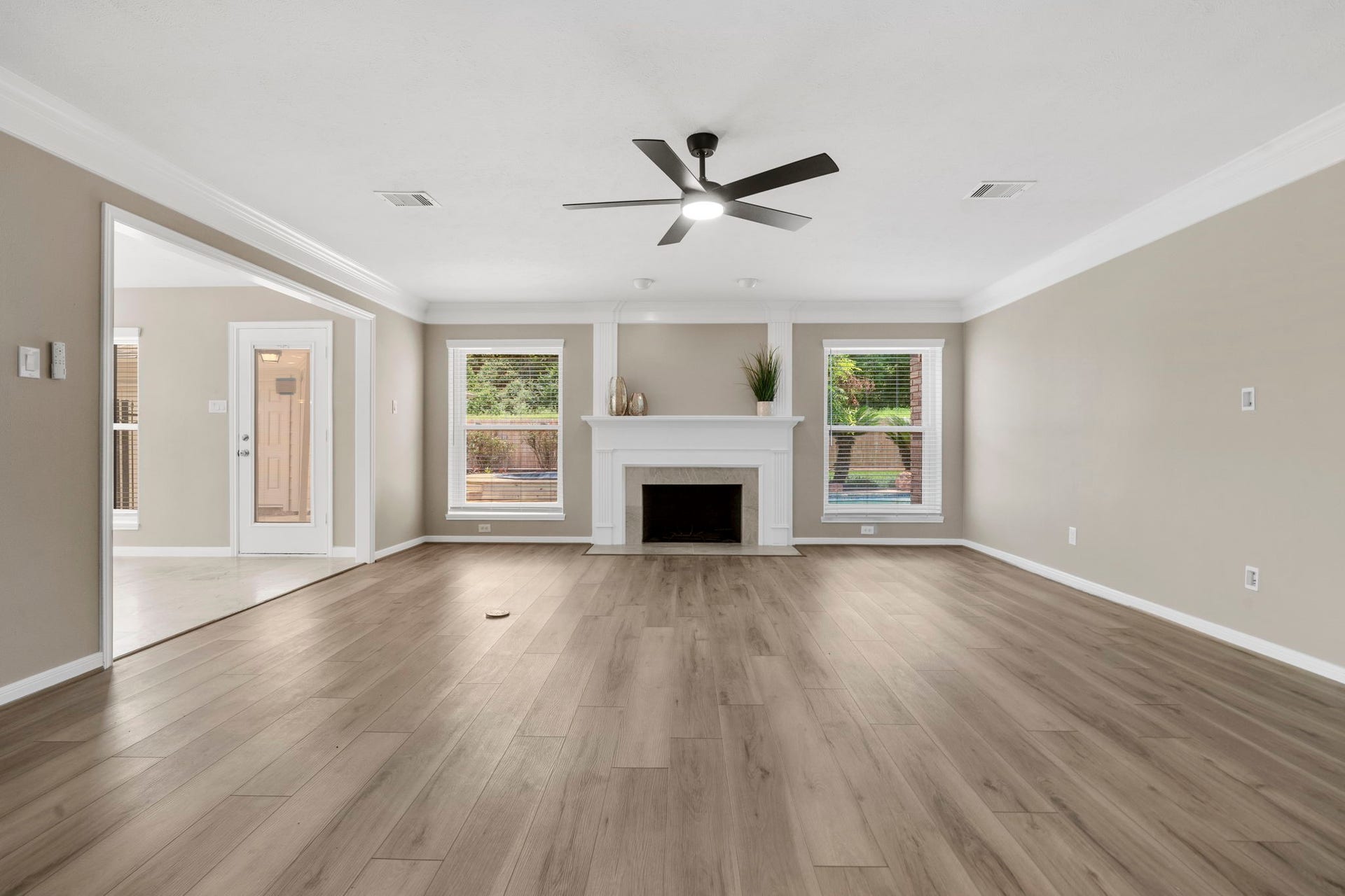 The spacious family room centers around a beautifully remodeled fireplace, framed by classic millwork & windows overlooking the backyard. An open connection to the kitchen and breakfast area creates an effortless flow for everyday living.