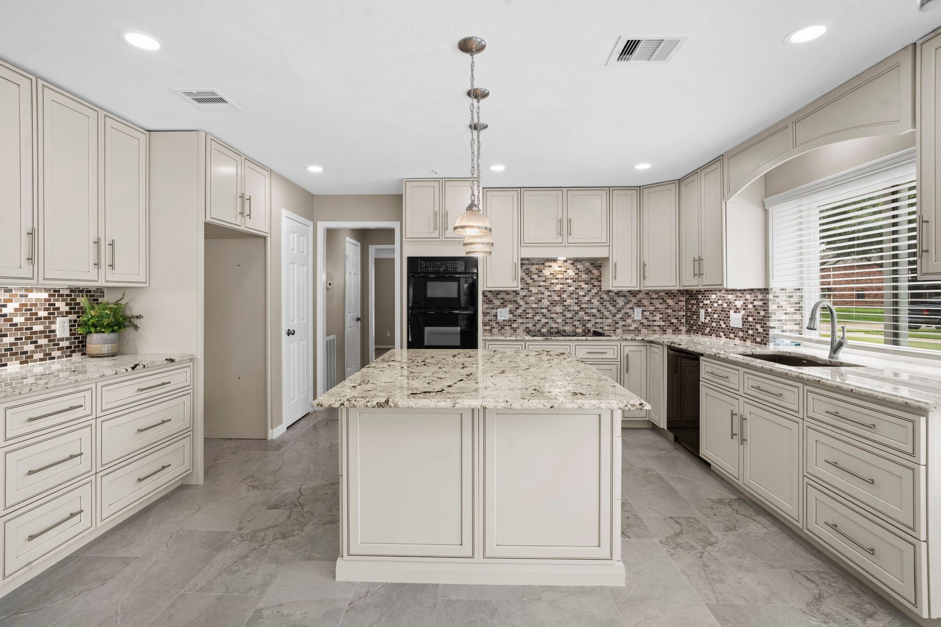 The spacious kitchen is designed with exceptional storage, expansive prep space & a large center island that anchors the room.