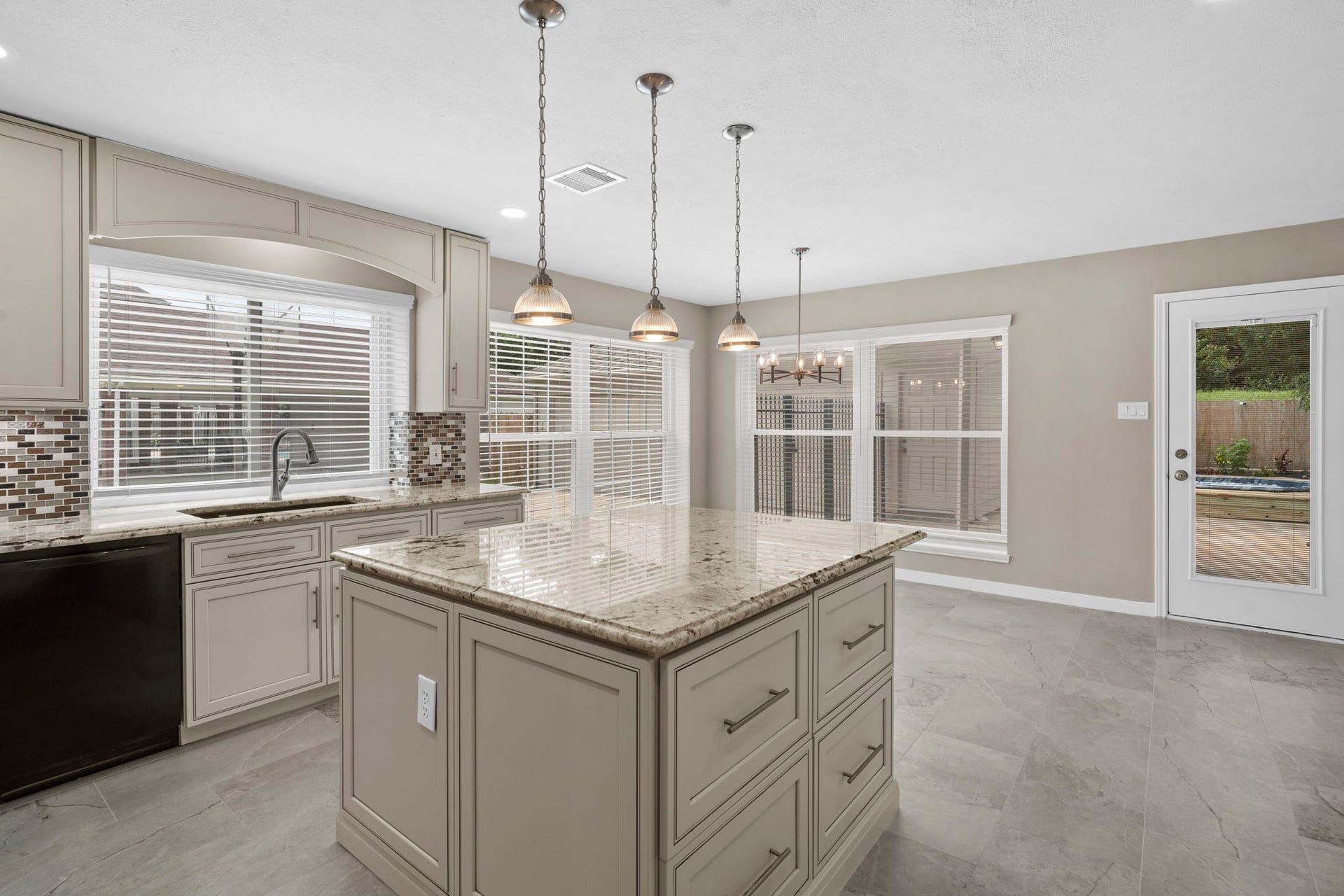 A deep undermount sink paired with a pull-down faucet offers everyday functionality.