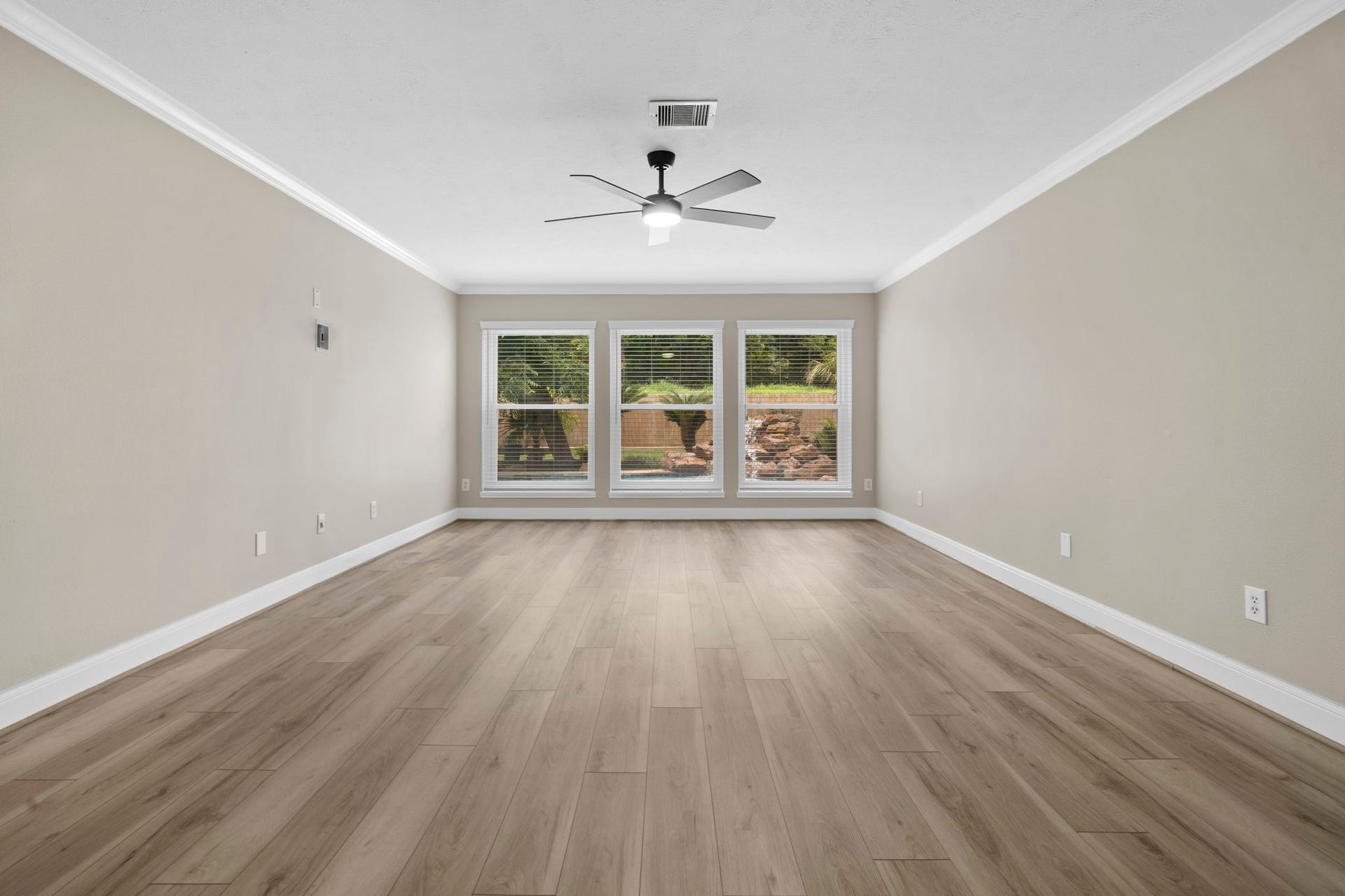 The spacious primary suite offers a peaceful retreat with fresh designer paint, updated flooring & views overlooking the backyard and pool.
