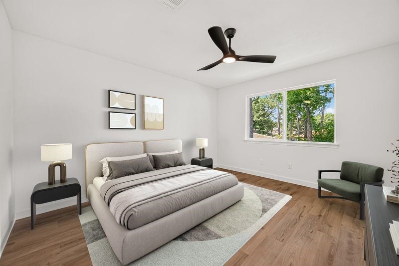 Bright and airy bedroom with modern furnishings, featuring a large window showcasing serene outdoor views.
