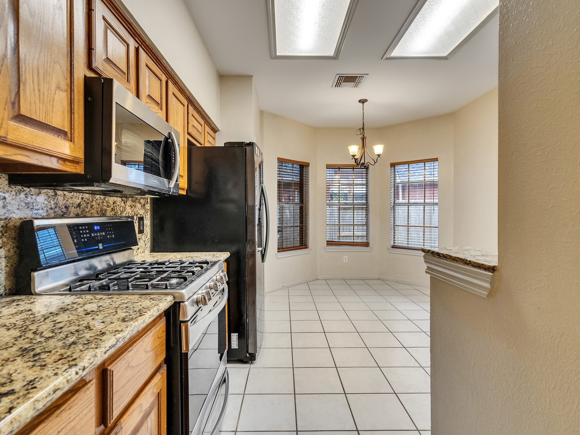 The kitchen is equipped with granite counter tops and all stainless steel appliances