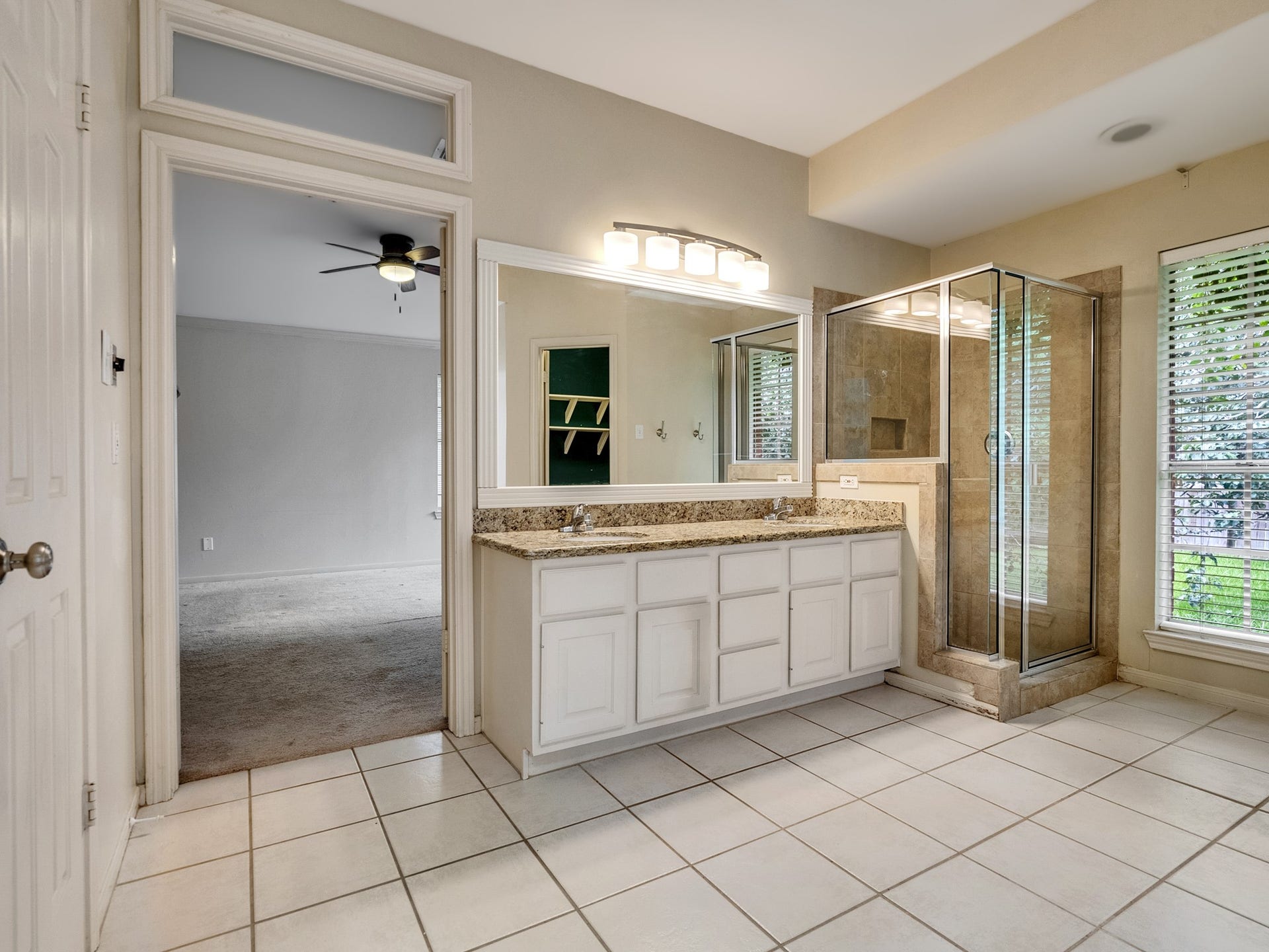 Primary bath comes with double sinks in the vanity area and a separate standing shower