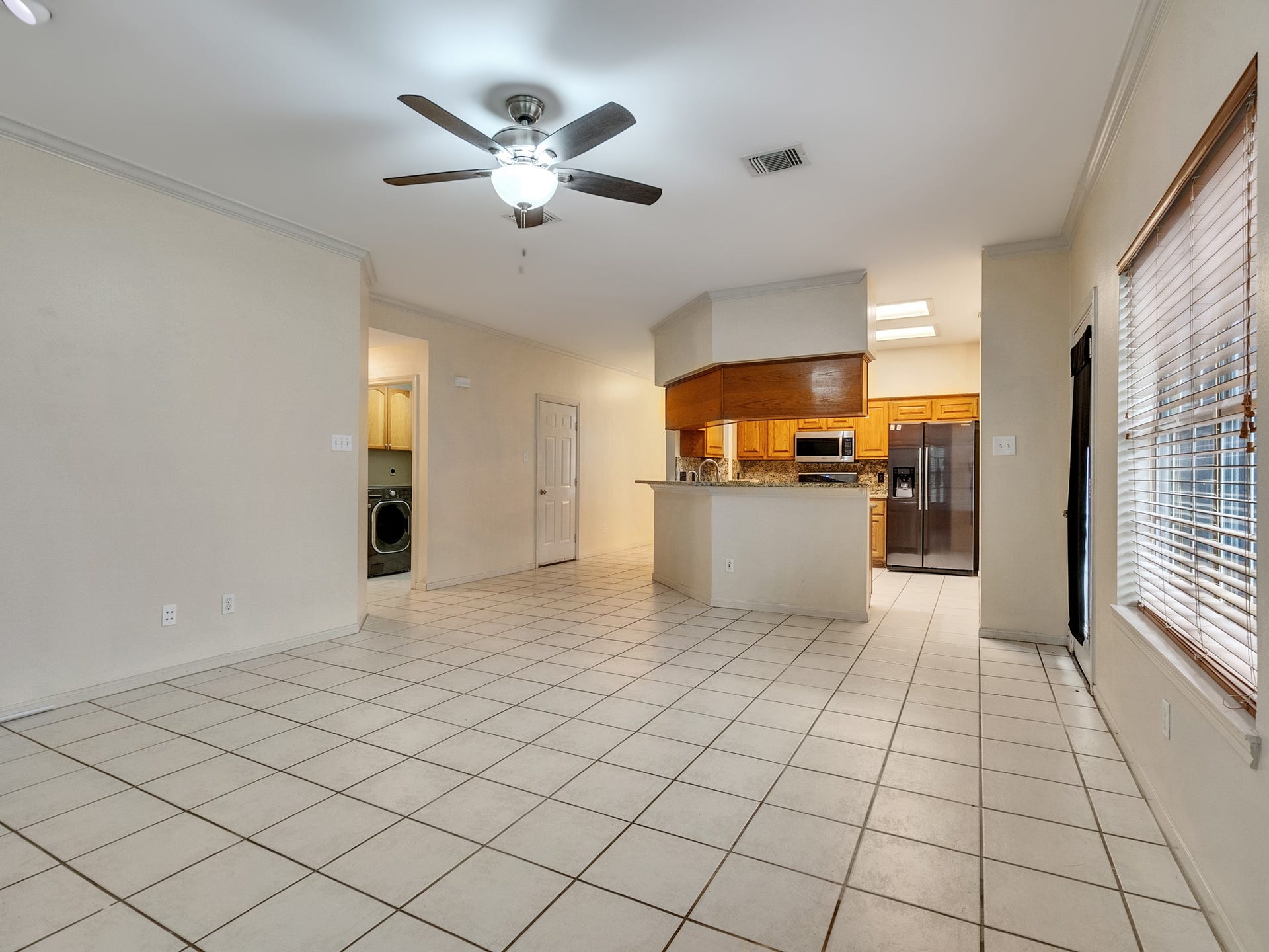 View of living room to the kitchen with backyard access to the right